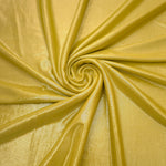 Swirled Antique Gold metallic foiled spandex showing fluid movement and luminous sheen for dresses, dancewear and stage costumes