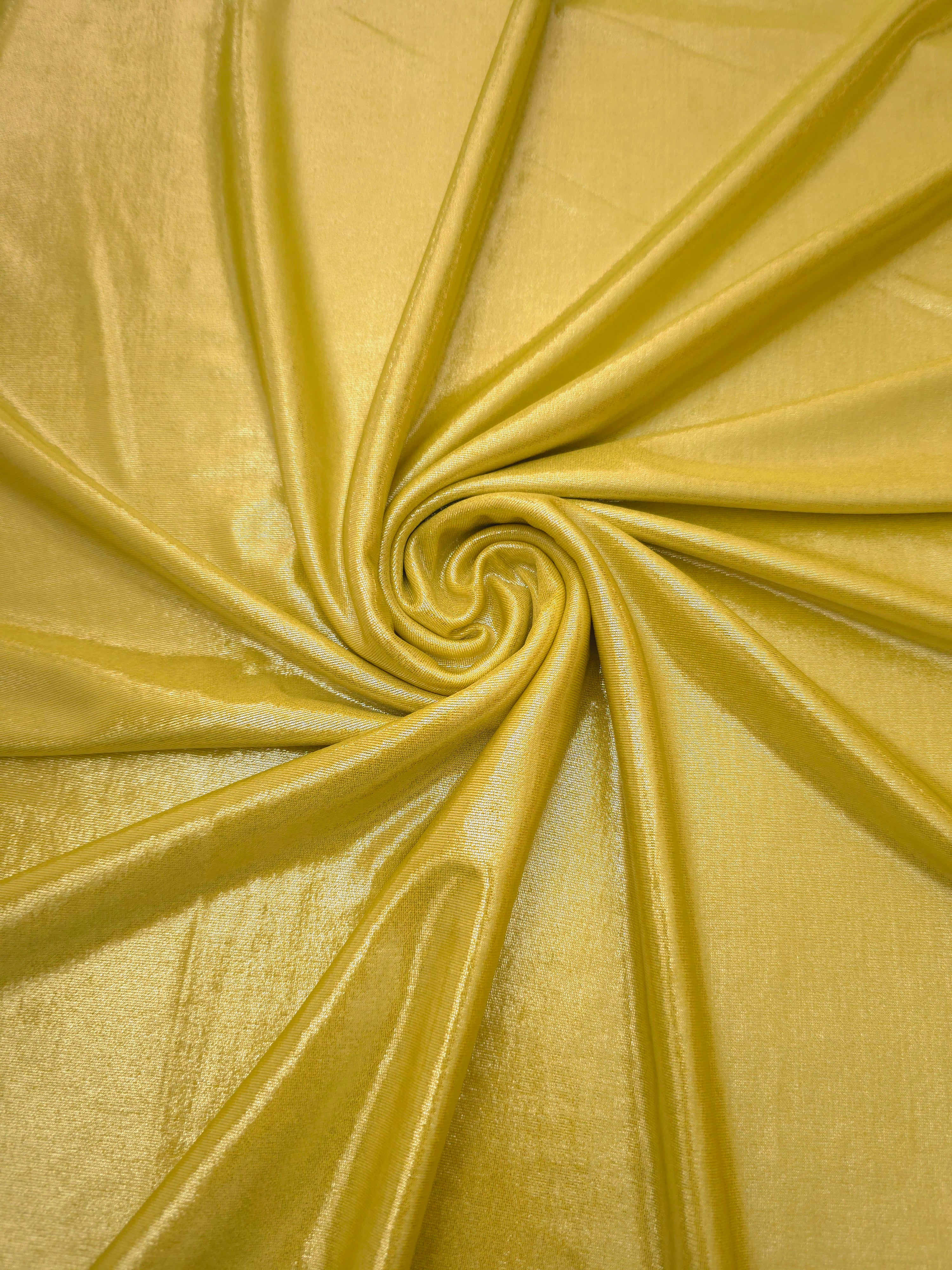 Swirled Antique Gold metallic foiled spandex showing fluid movement and luminous sheen for dresses, dancewear and stage costumes