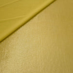 Soft fold of Antique Gold metallic foiled spandex highlighting reflective sheen and supple movement for dresses and stagewear