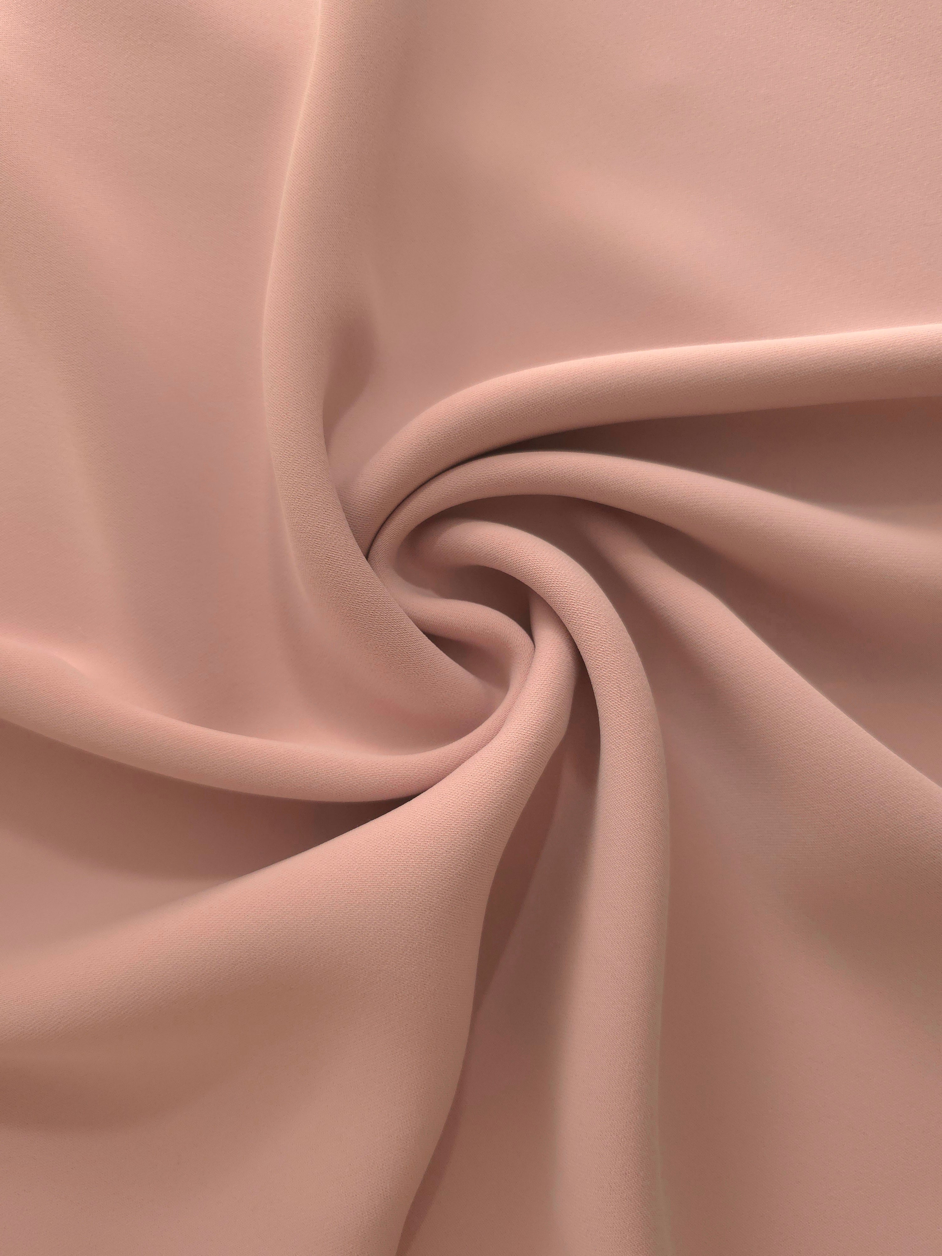 Antique Rose Beige mechanical polyester crepe in layered folds, showing gentle stretch and structure for dressmaking