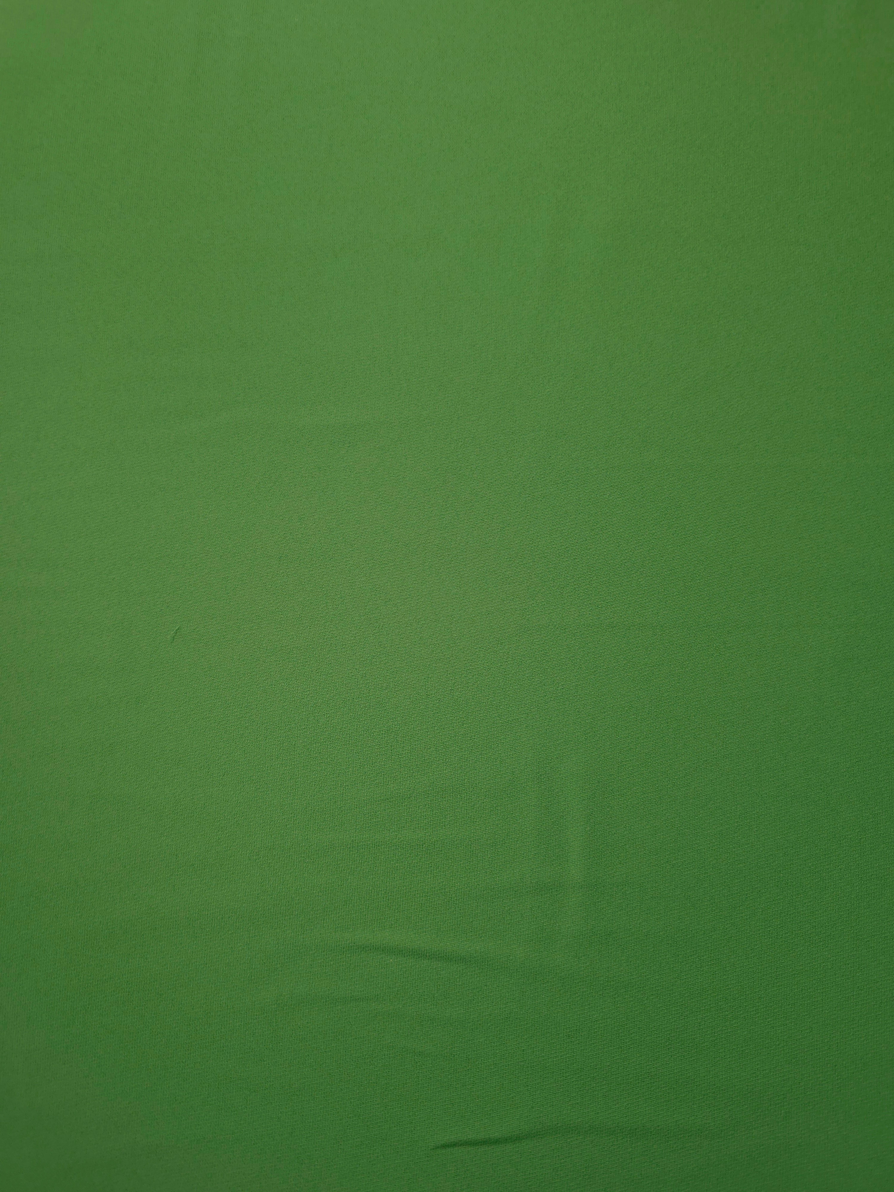 Avocado Green polyester crepe shown flat, a smooth woven apparel fabric with a refined soft-touch finish