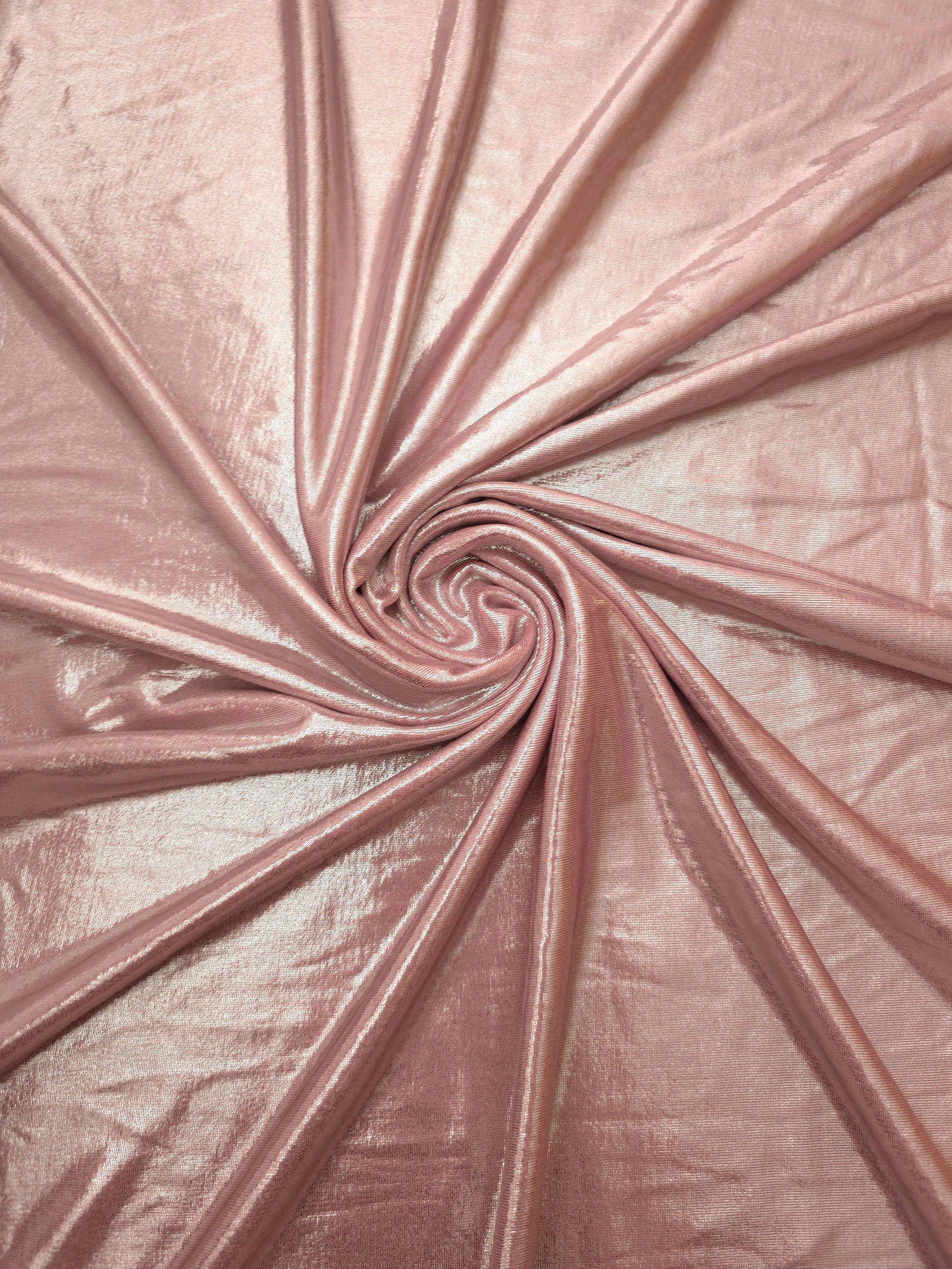 Swirled Blush Champagne metallic foiled spandex showing fluid movement and luminous sheen for dresses, dancewear and stage costumes
