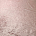 Blush Champagne shimmer stretch fabric close-up, revealing metallic foil texture and reflective detail for fashion and costume sewing