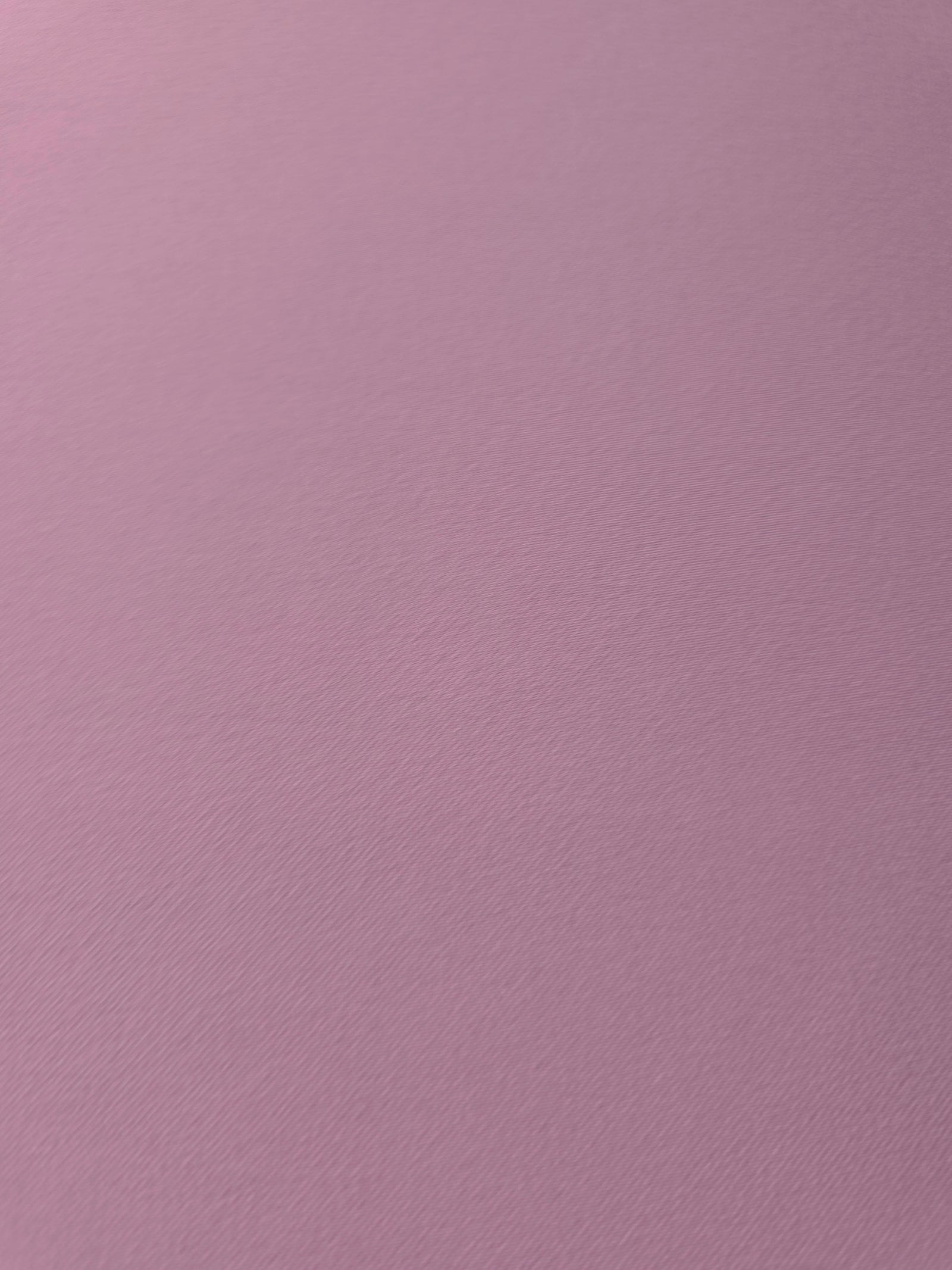 Texture detail of Blush Mauve mechanical polyester crepe, a smooth woven fabric with a soft silky hand