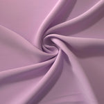 Blush Mauve opaque polyester crepe in a spiral drape, showing flowing form for skirts and modest garments