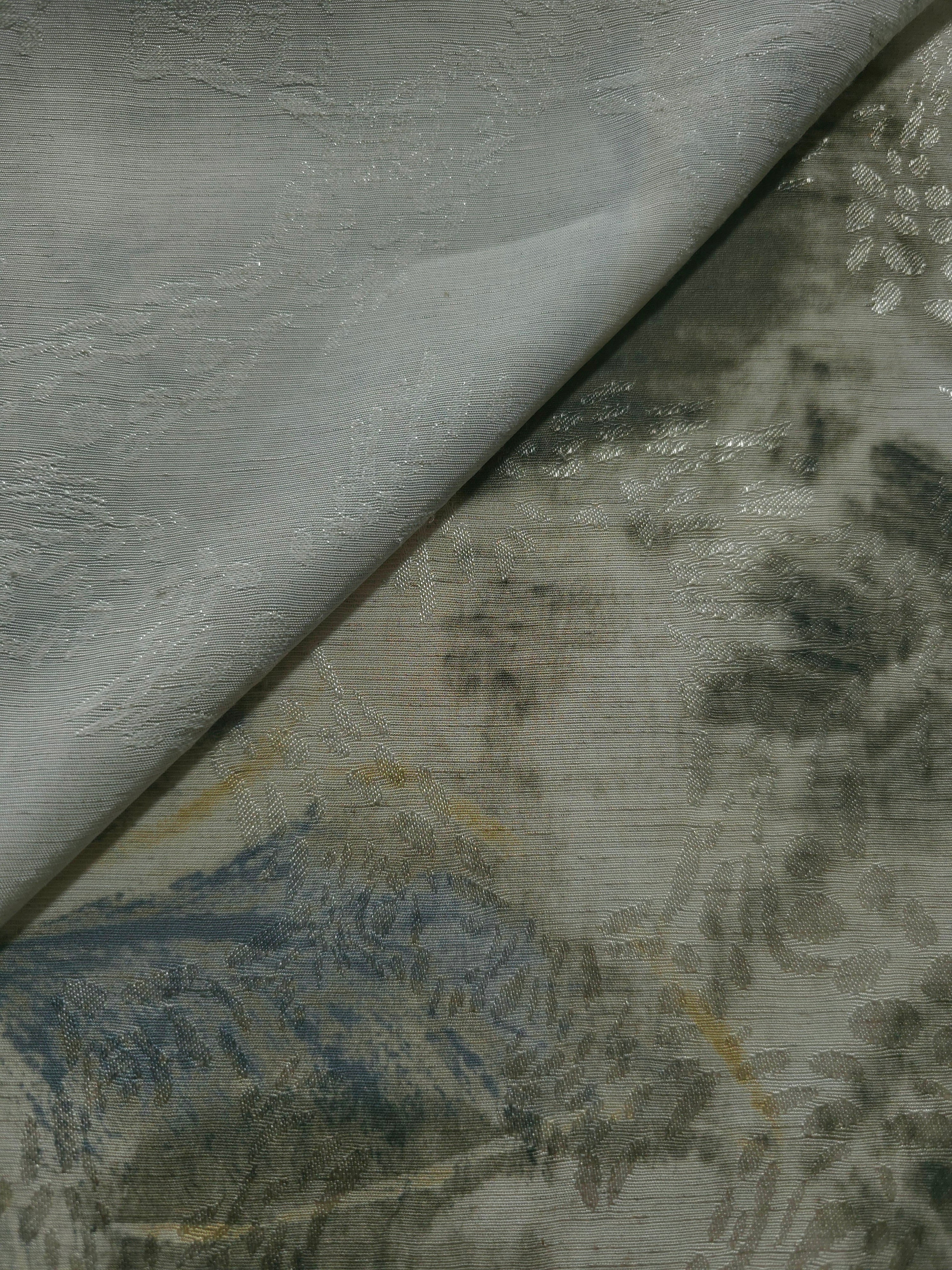 Blue botanical shadow linen-look jacquard fabric close-up with raised woven texture and tonal leaf pattern.