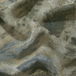 Blue botanical shadow linen-look jacquard fabric draped to show soft structure and woven pattern depth.