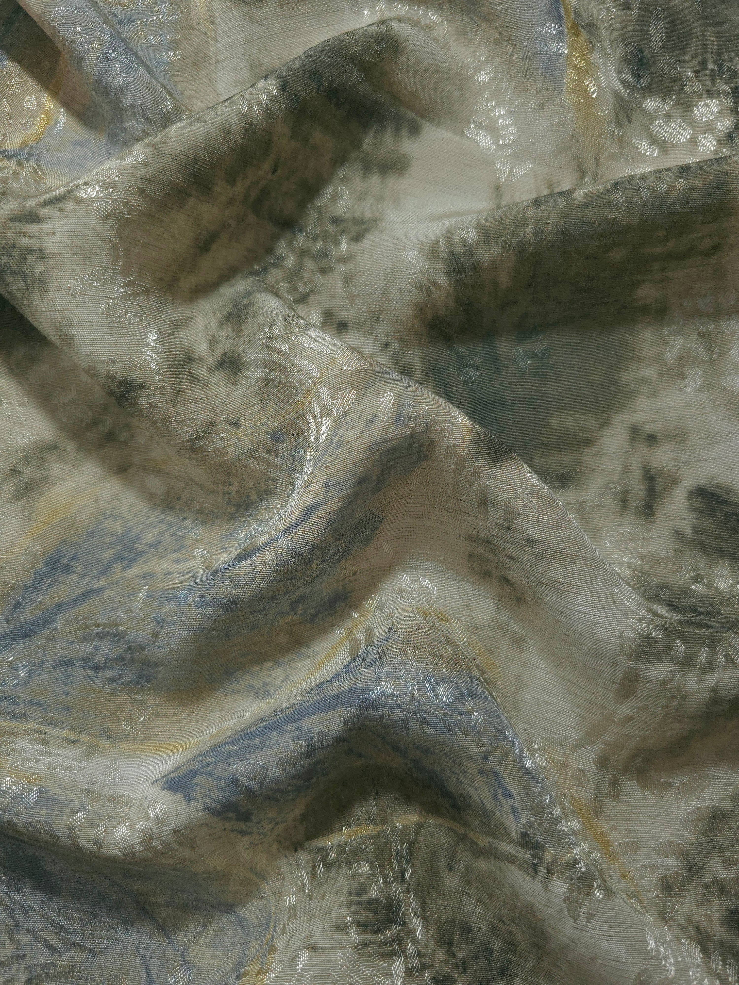 Blue botanical shadow linen-look jacquard fabric draped to show soft structure and woven pattern depth.