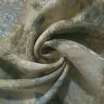 Blue botanical shadow jacquard fabric folded to show linen-like texture, body and apparel drape.