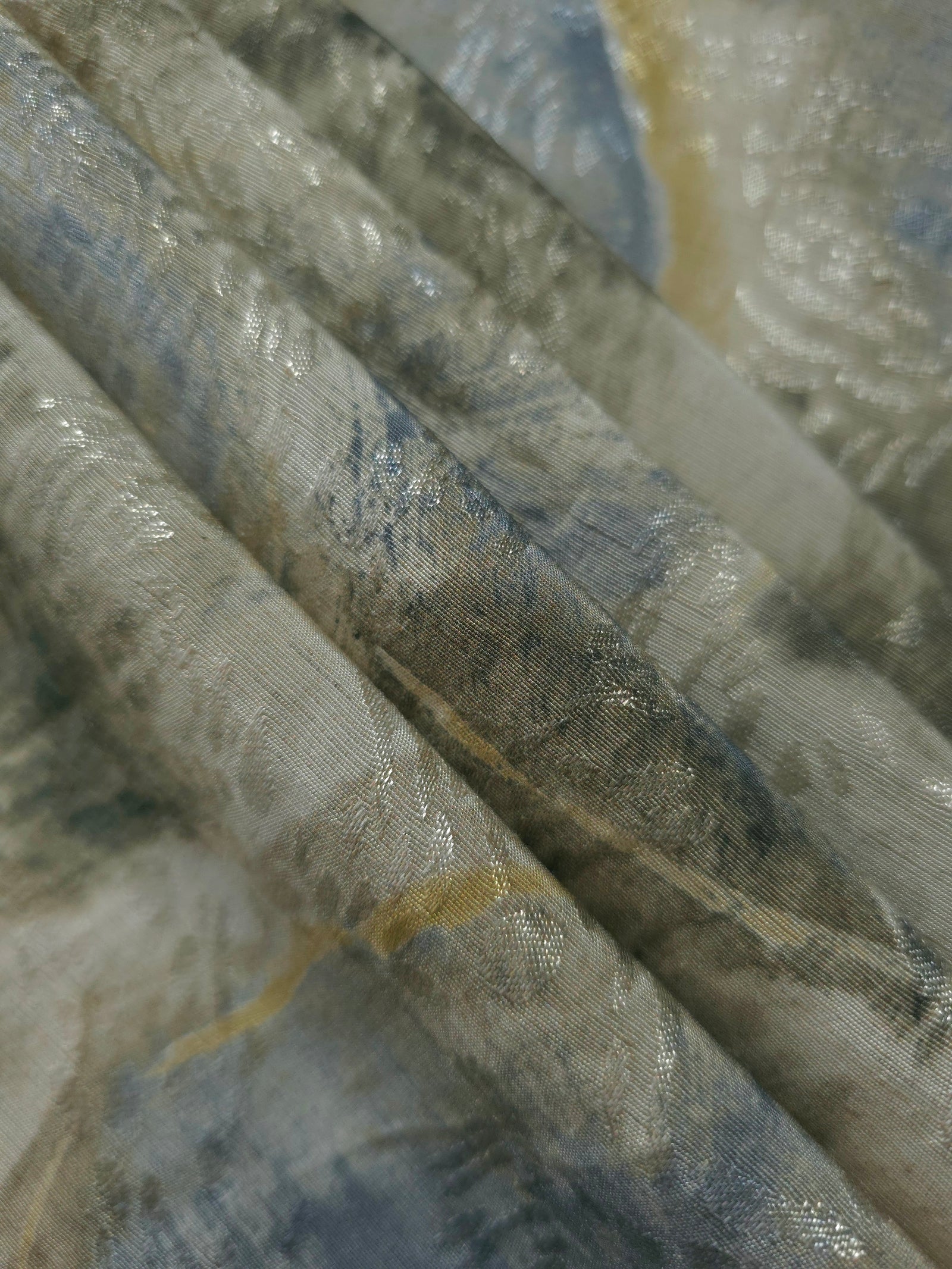 Reverse side of blue botanical shadow jacquard fabric showing woven structure and linen-look texture.