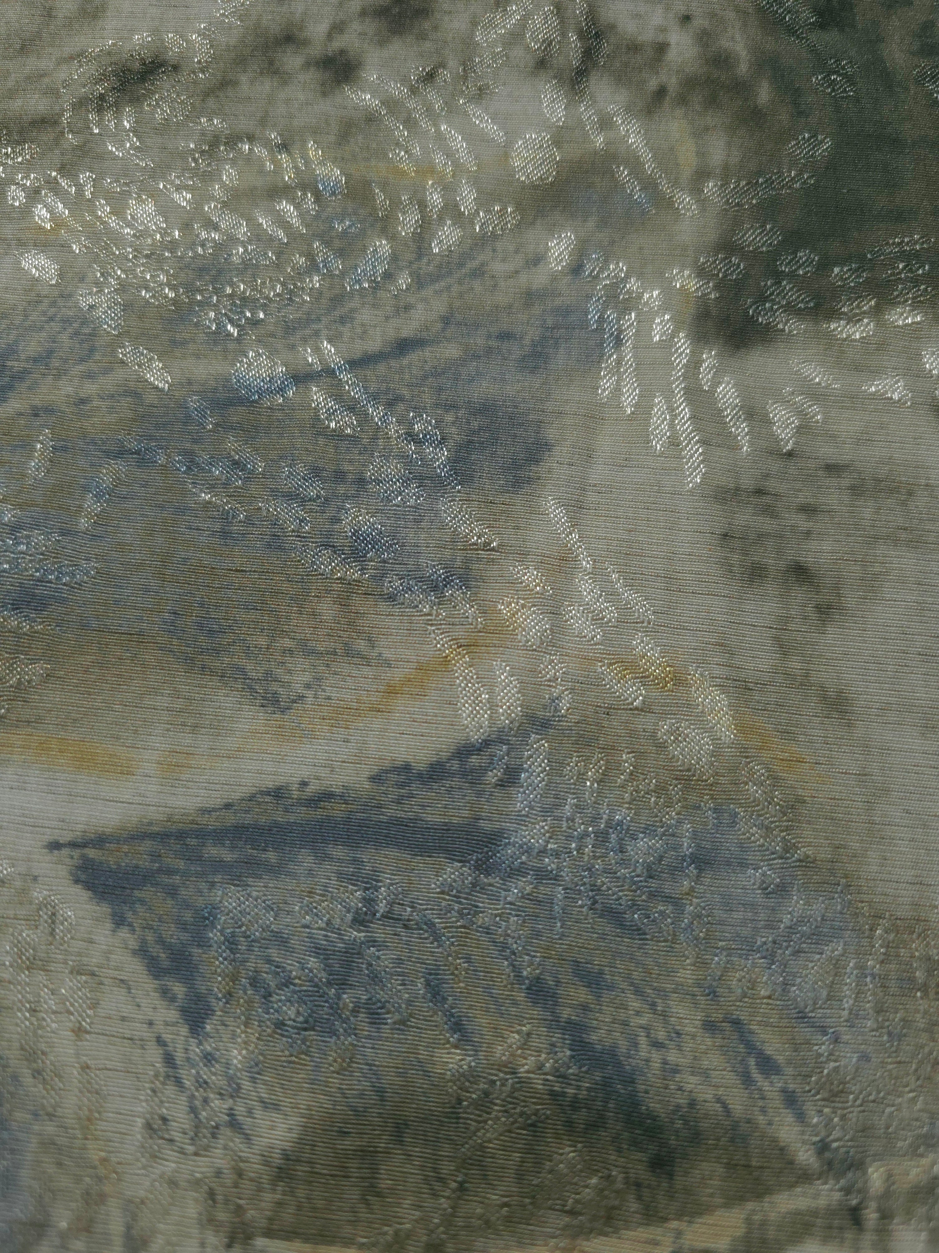 Texture view of blue botanical shadow linen-look jacquard fabric with raised tonal woven leaf motif.