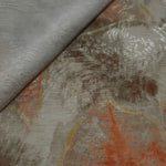 Orange botanical shadow linen-look jacquard fabric close-up showing raised woven texture and leaf motif.