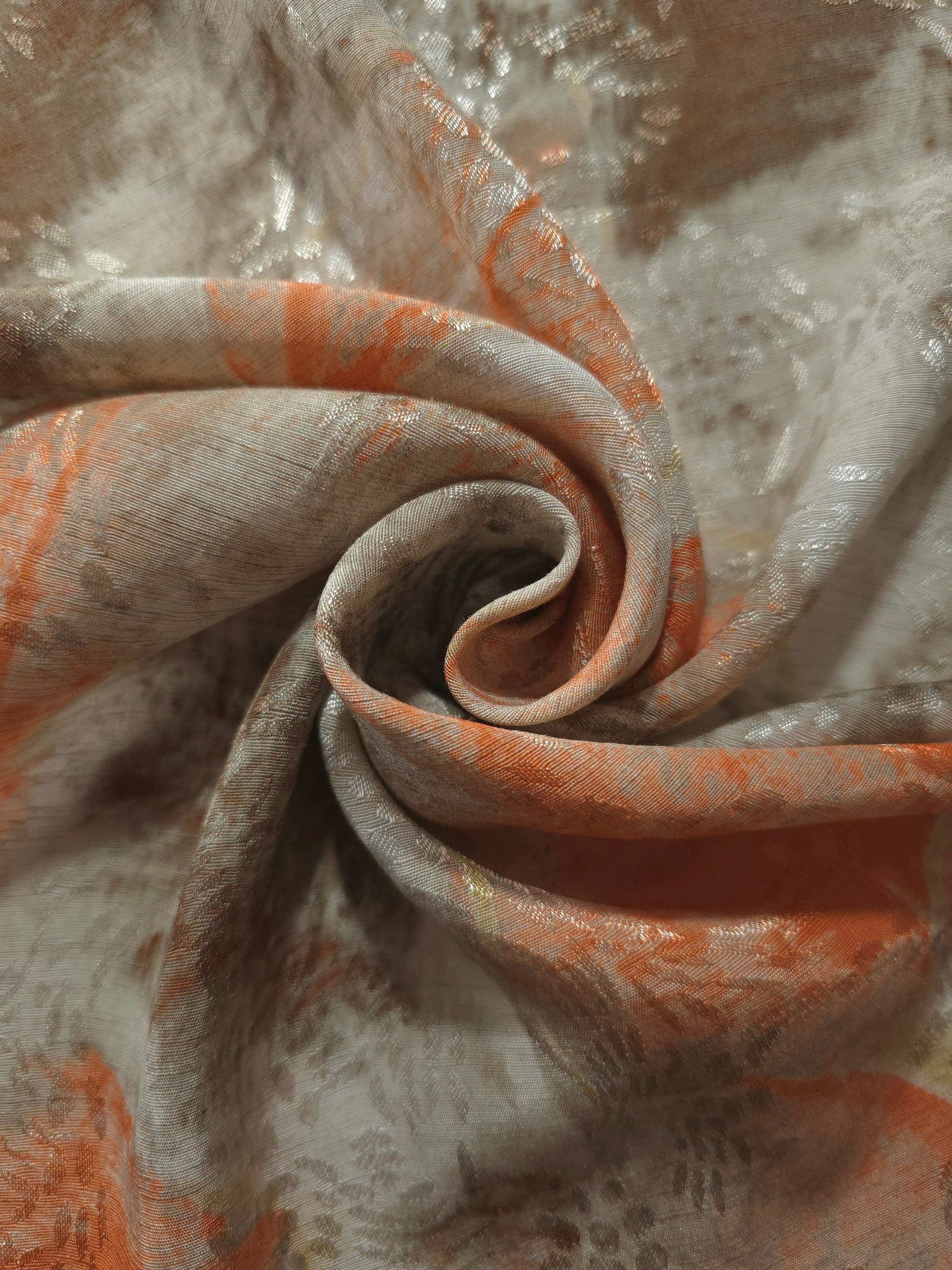 Orange botanical shadow linen-look jacquard fabric folded to show body, texture and pattern depth.