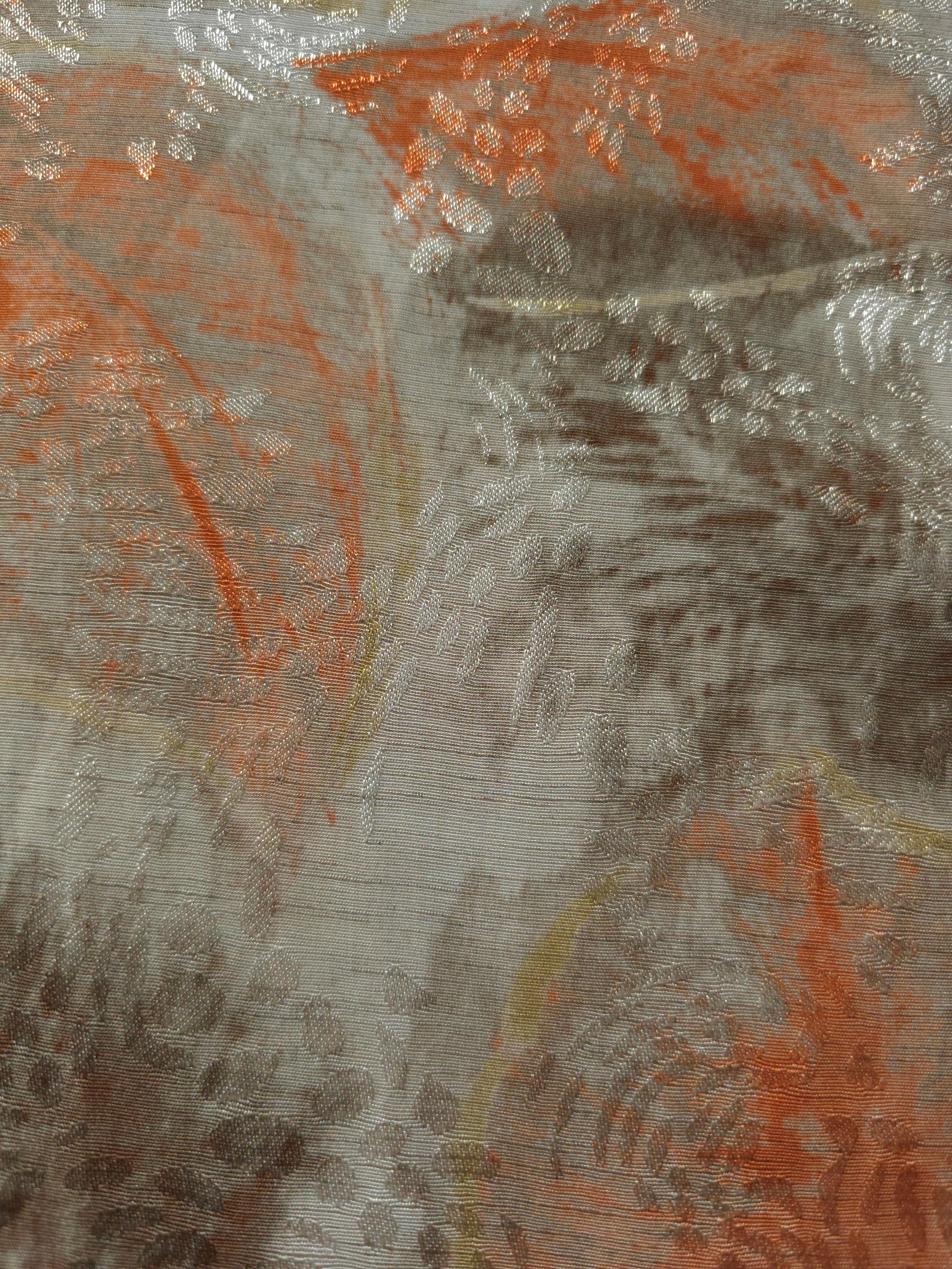 Orange botanical shadow linen-look jacquard fabric pattern overview with tonal woven leaf design.