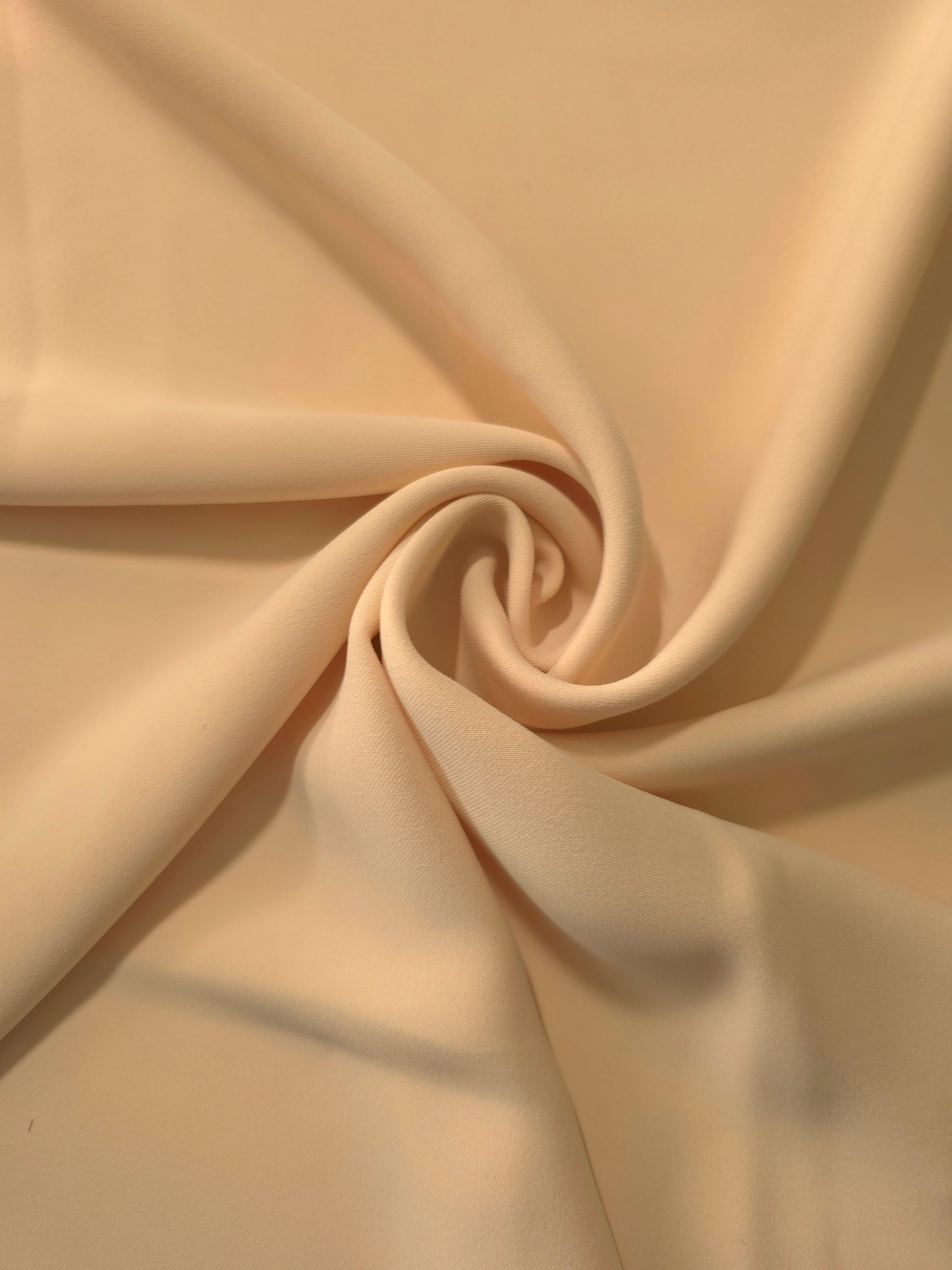 Swirled Camel Beige Korean crepe showing fluid movement and silky drape for dresses and occasionwear