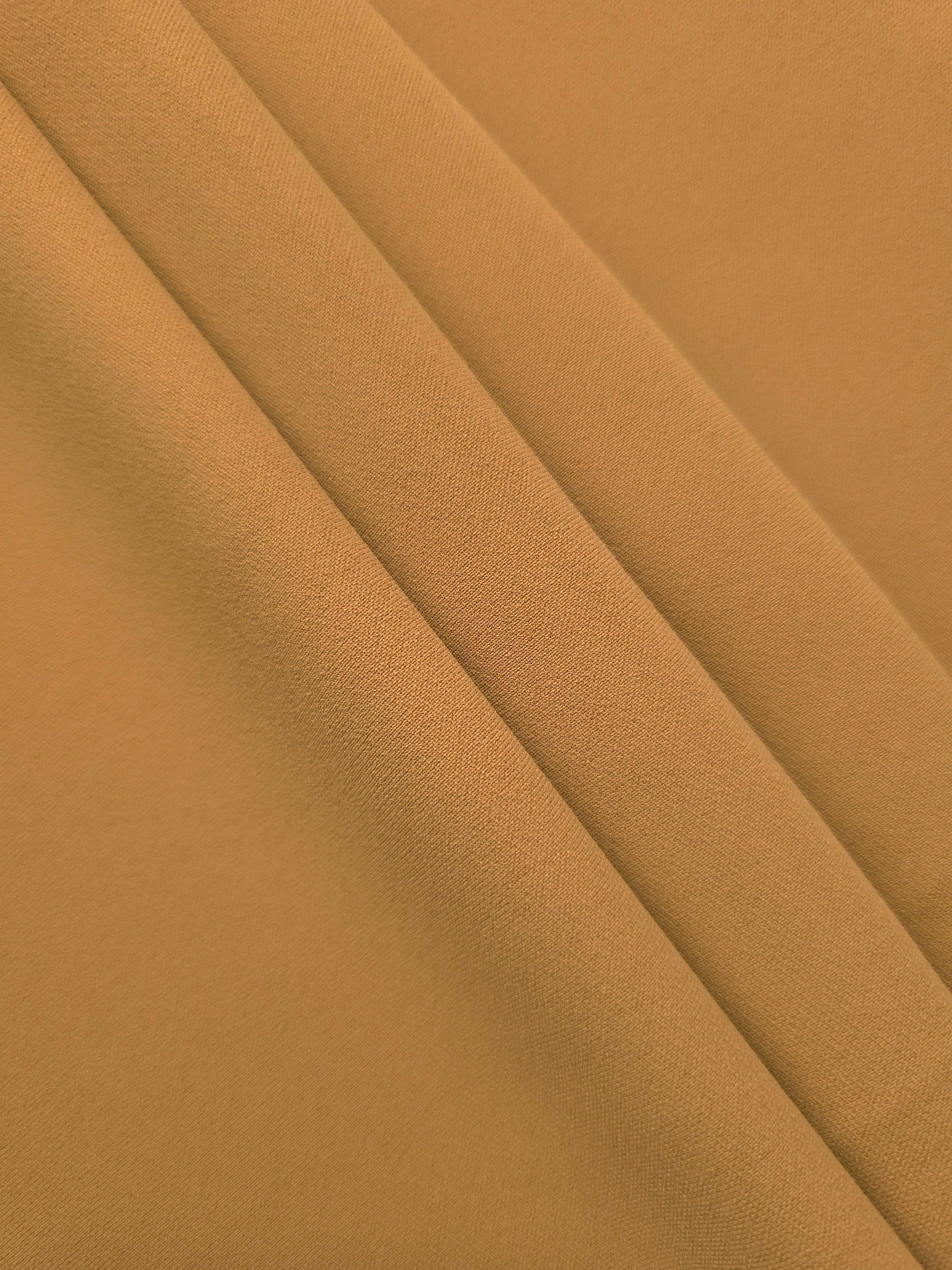 Layered Caramel Brown mechanical polyester crepe showing soft structure and gentle stretch for light tailoring