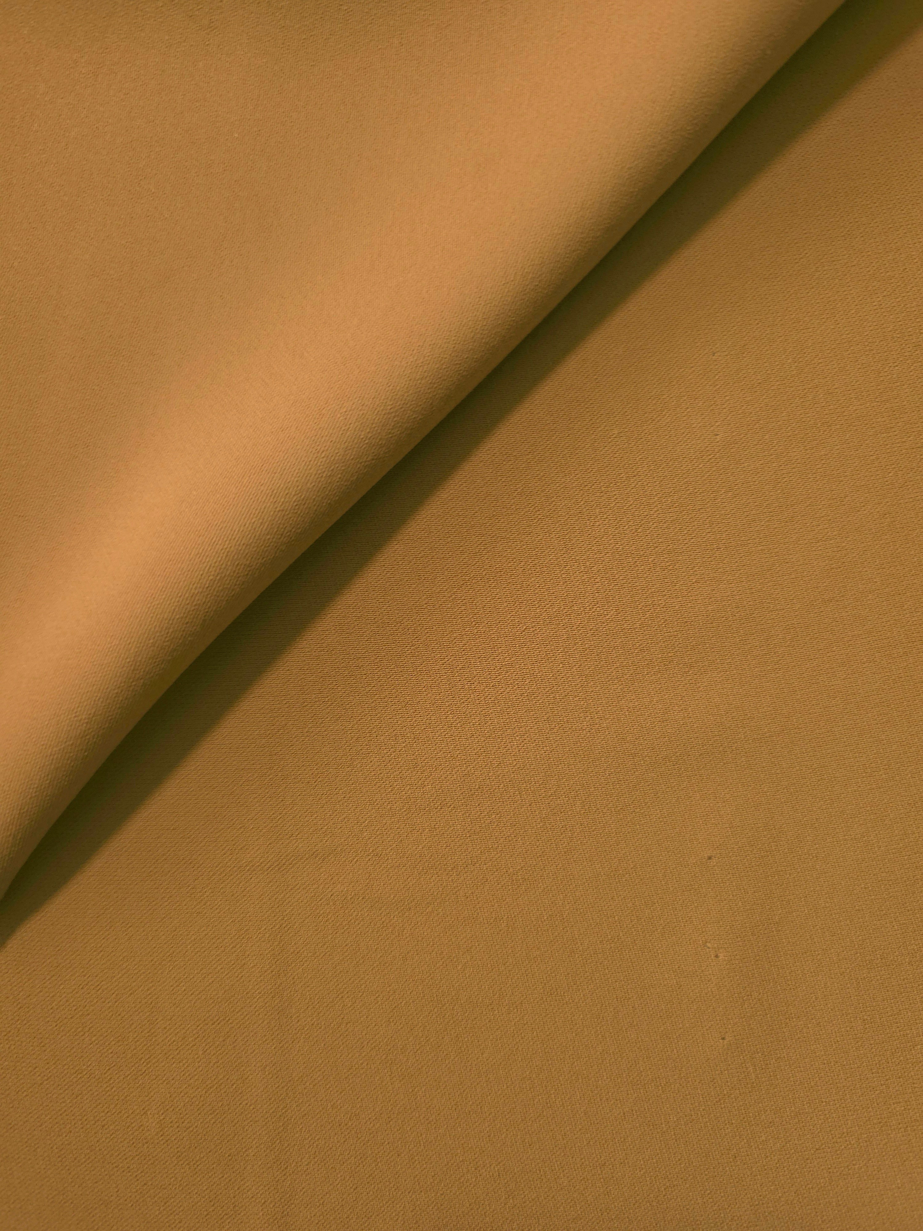 Caramel Brown Italian crepe in a soft fold, showing fluid drape for blouses, dresses and flowing skirts