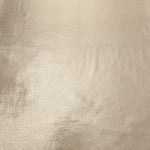 Champagne Beige shimmer metallic foiled spandex shown flat, displaying reflective finish for dance costumes, skirts and event apparel