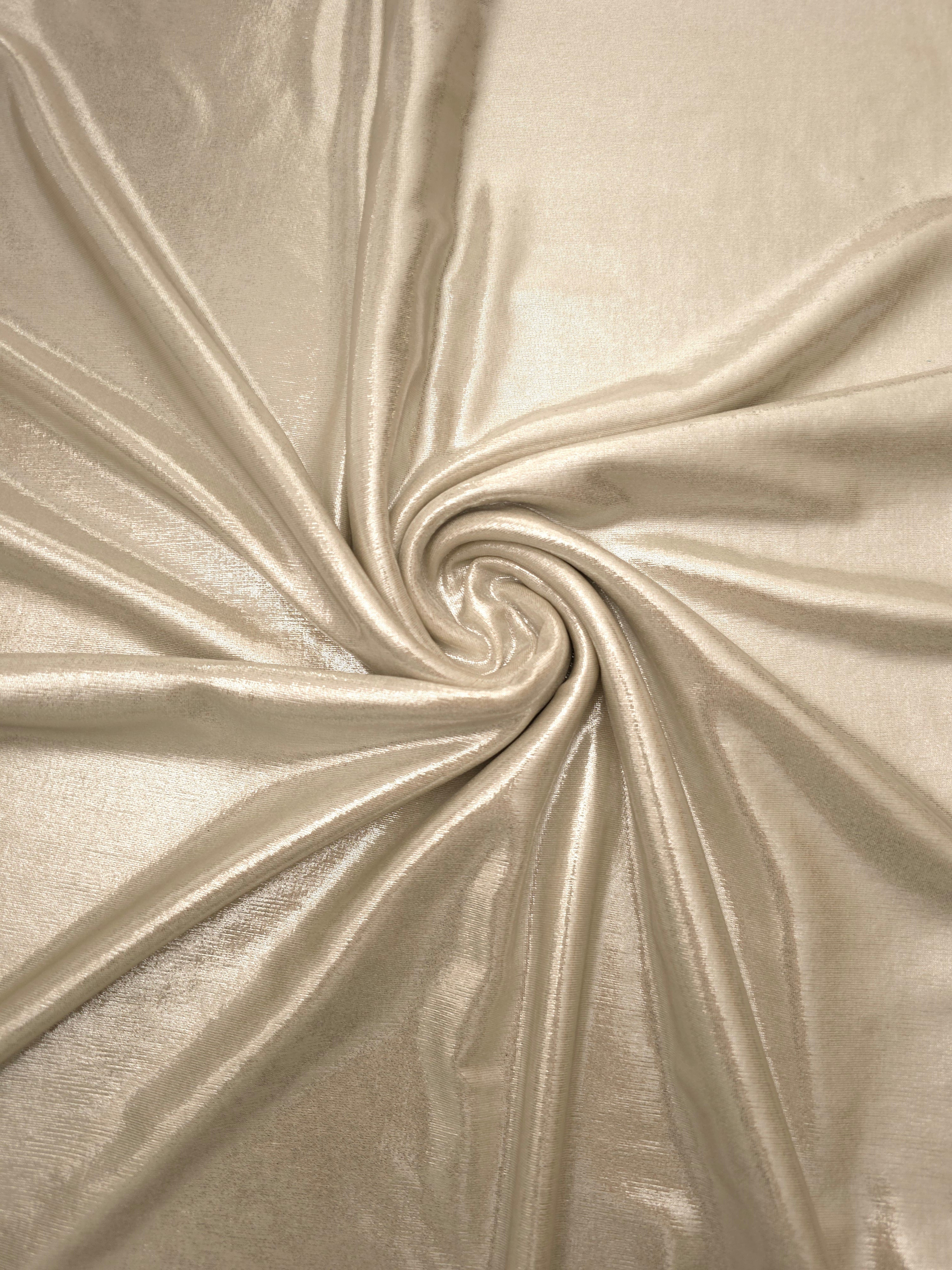 Champagne Beige foiled spandex styled in a swirl, revealing metallic shine and flexible drape for dance costumes and occasion looks