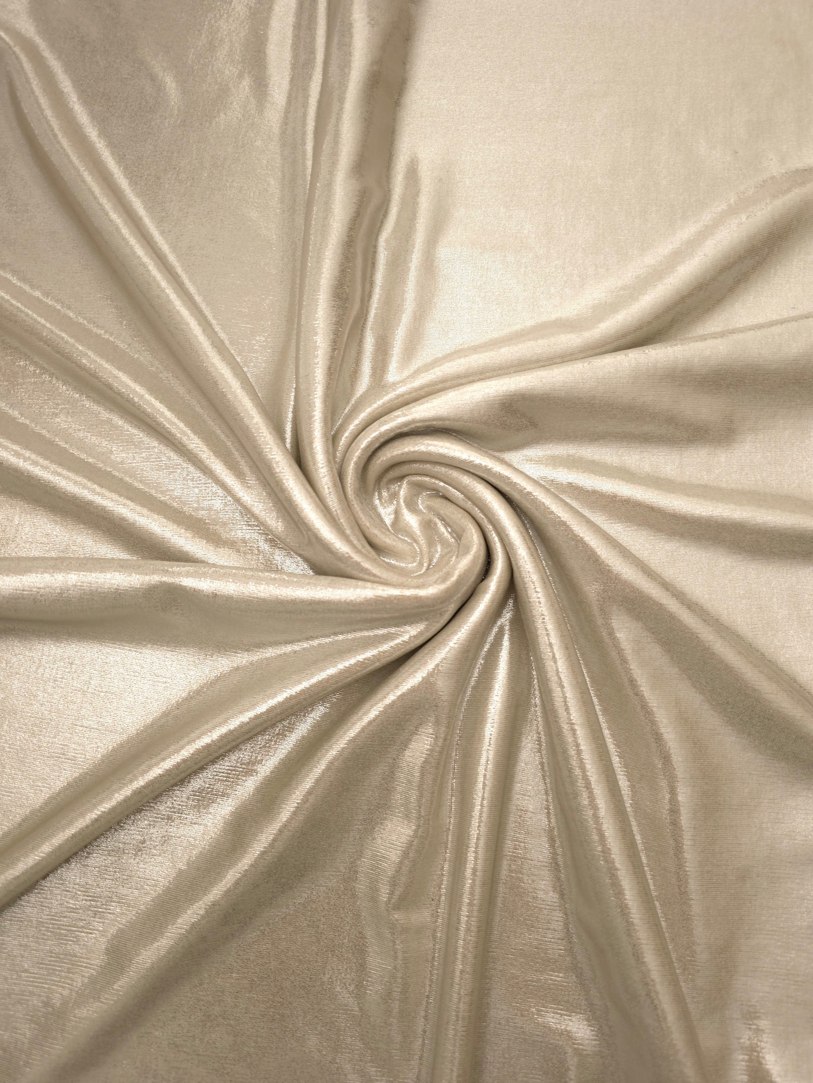 Champagne Beige foiled spandex styled in a swirl, revealing metallic shine and flexible drape for dance costumes and occasion looks