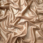 Softly draped Champagne Taupe foiled spandex fabric showing fluid shape and metallic shimmer for dresses, stage costumes and eventwear