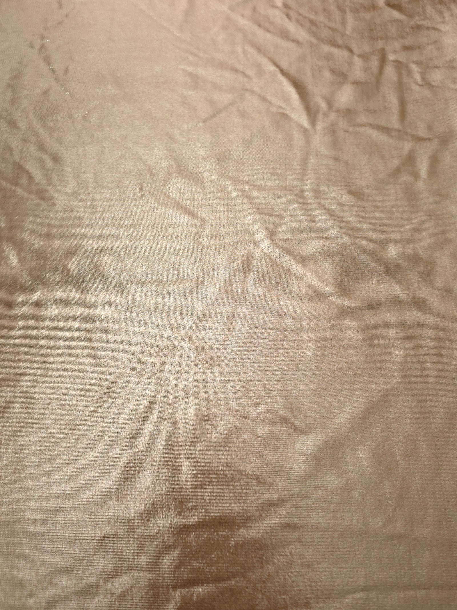 Flat Champagne Taupe foiled stretch fabric with bright metallic reflection, ideal for performancewear, evening pieces and creative sewing