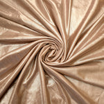 Flowing swirl of Champagne Taupe metallic stretch fabric, showing dynamic foil reflection for stagewear, skirts and creative fashion