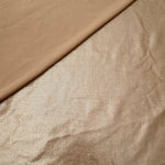 Softly folded Champagne Taupe foiled spandex showing metallic shine and flexible hand for costumes, eveningwear and creative sewing