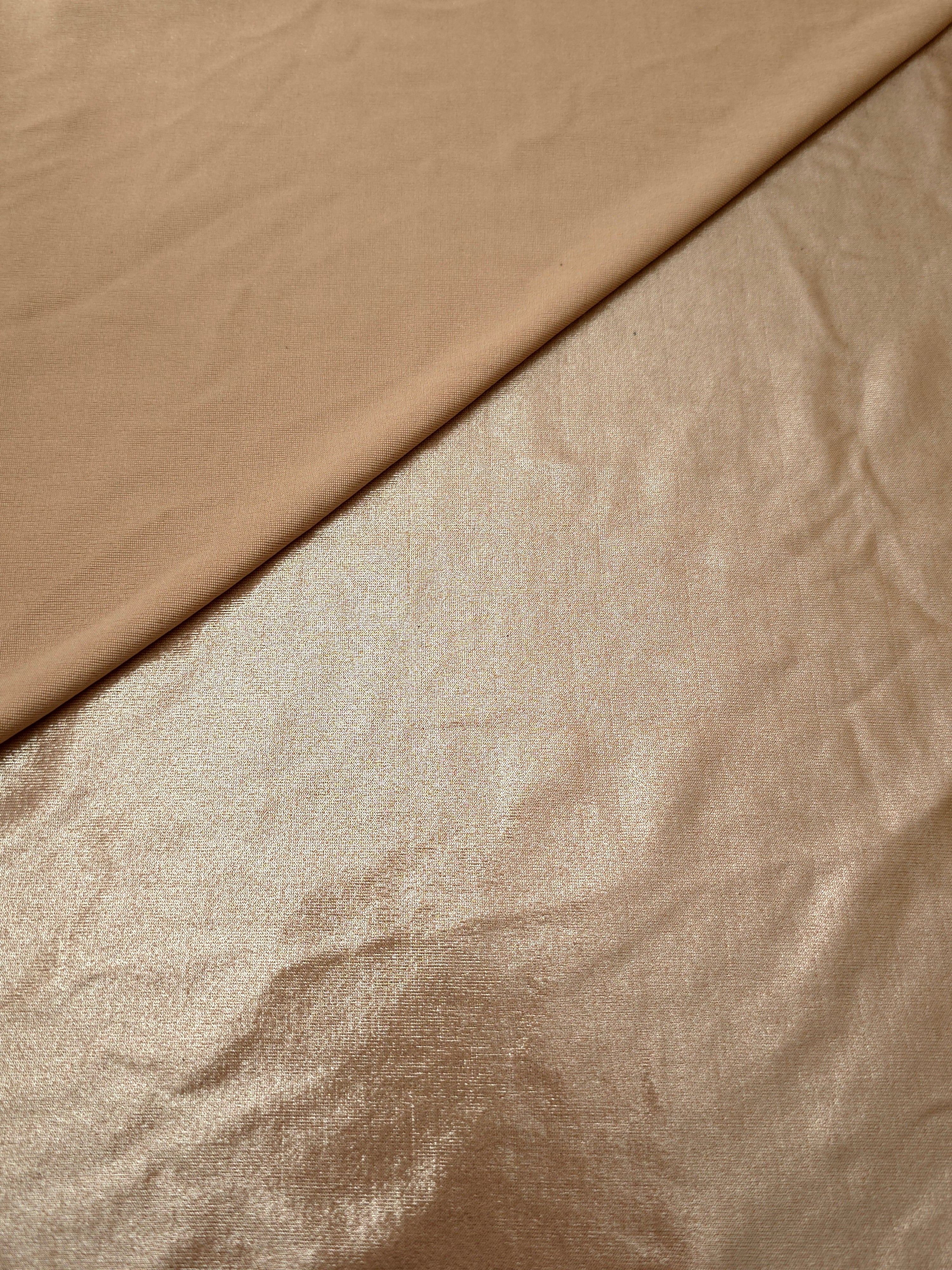 Softly folded Champagne Taupe foiled spandex showing metallic shine and flexible hand for costumes, eveningwear and creative sewing