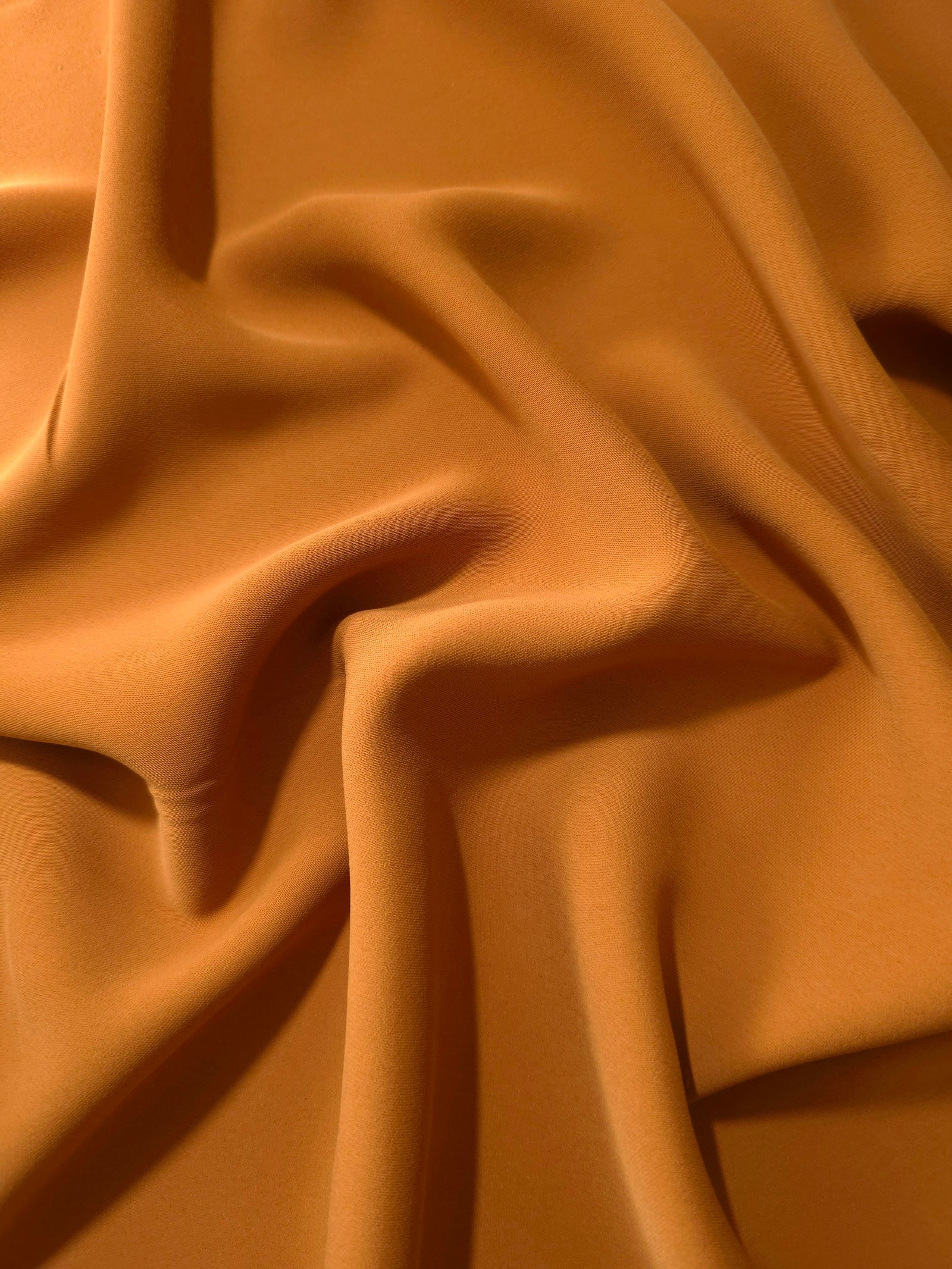 Long draped folds of Cinnamon Brown Korean crepe showing opaque coverage for abayas, dresses and modest wear