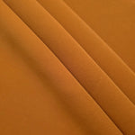 Layered Cinnamon Brown polyester crepe showing soft body and slight mechanical stretch for light tailoring