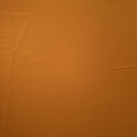 Flat surface of Cinnamon Brown Korean crepe, a 205 GSM opaque polyester fabric with smooth dressmaking character