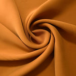 Circular drape of Cinnamon Brown polyester crepe showing flowing movement for occasion dresses and modest fashion