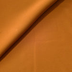 Soft-fold view of Cinnamon Brown Korean polyester crepe showing fluid drape for blouses, skirts and dresses