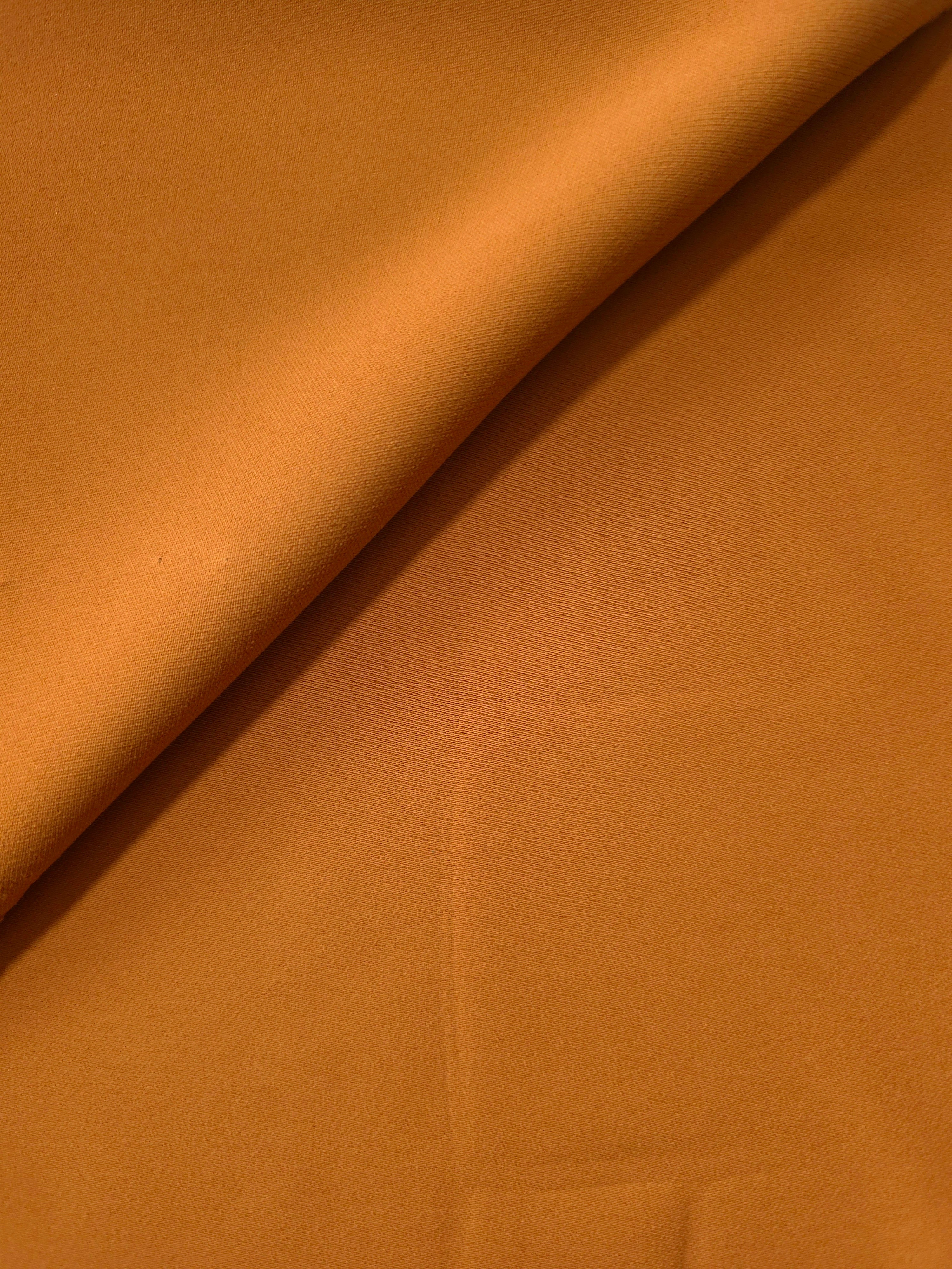 Soft-fold view of Cinnamon Brown Korean polyester crepe showing fluid drape for blouses, skirts and dresses