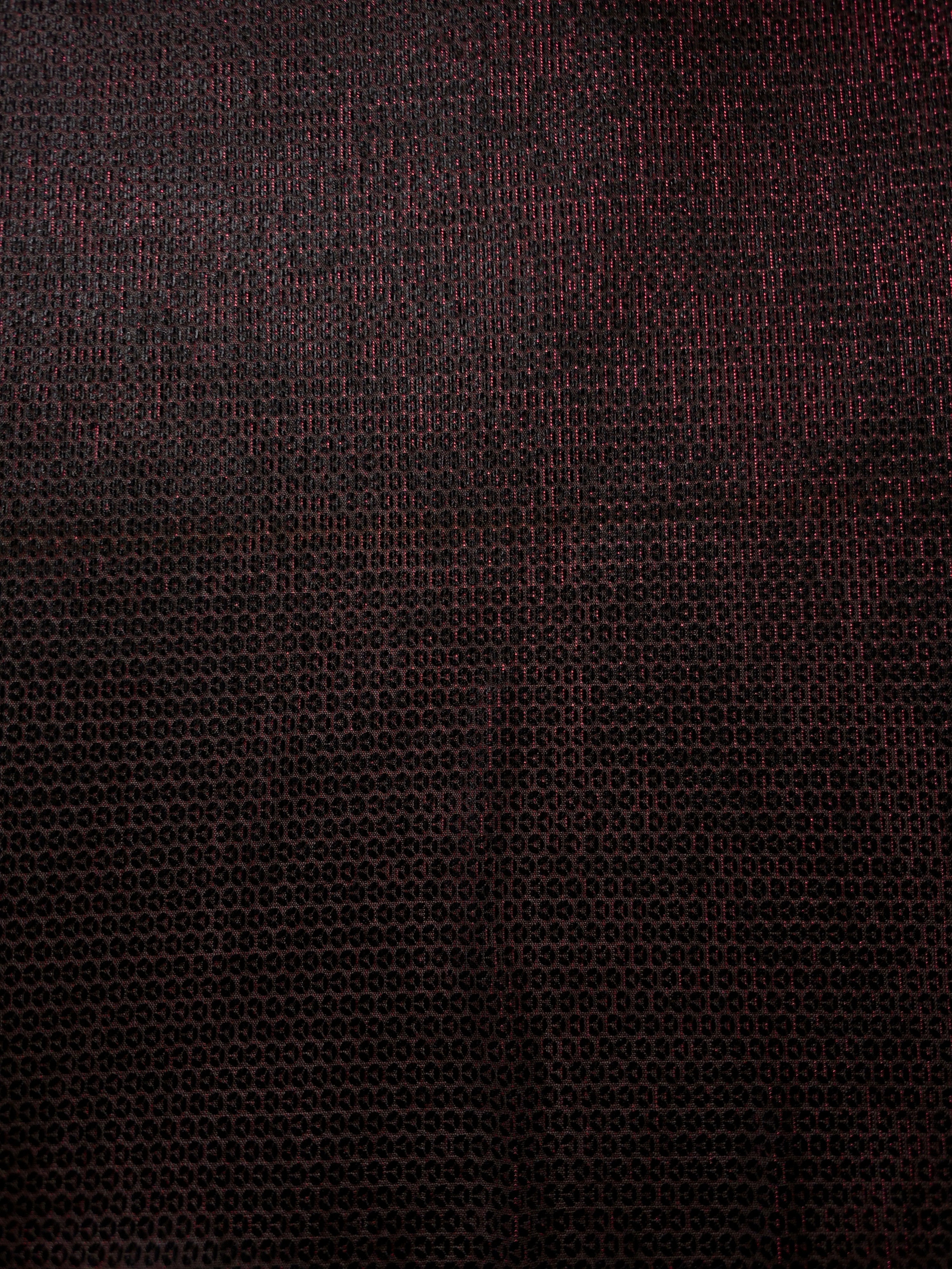 Close-up of Burgundy Red Sheer Circle Shimmer Stretch Tulle Fabric revealing the circular shimmer repeat and fine sheer mesh