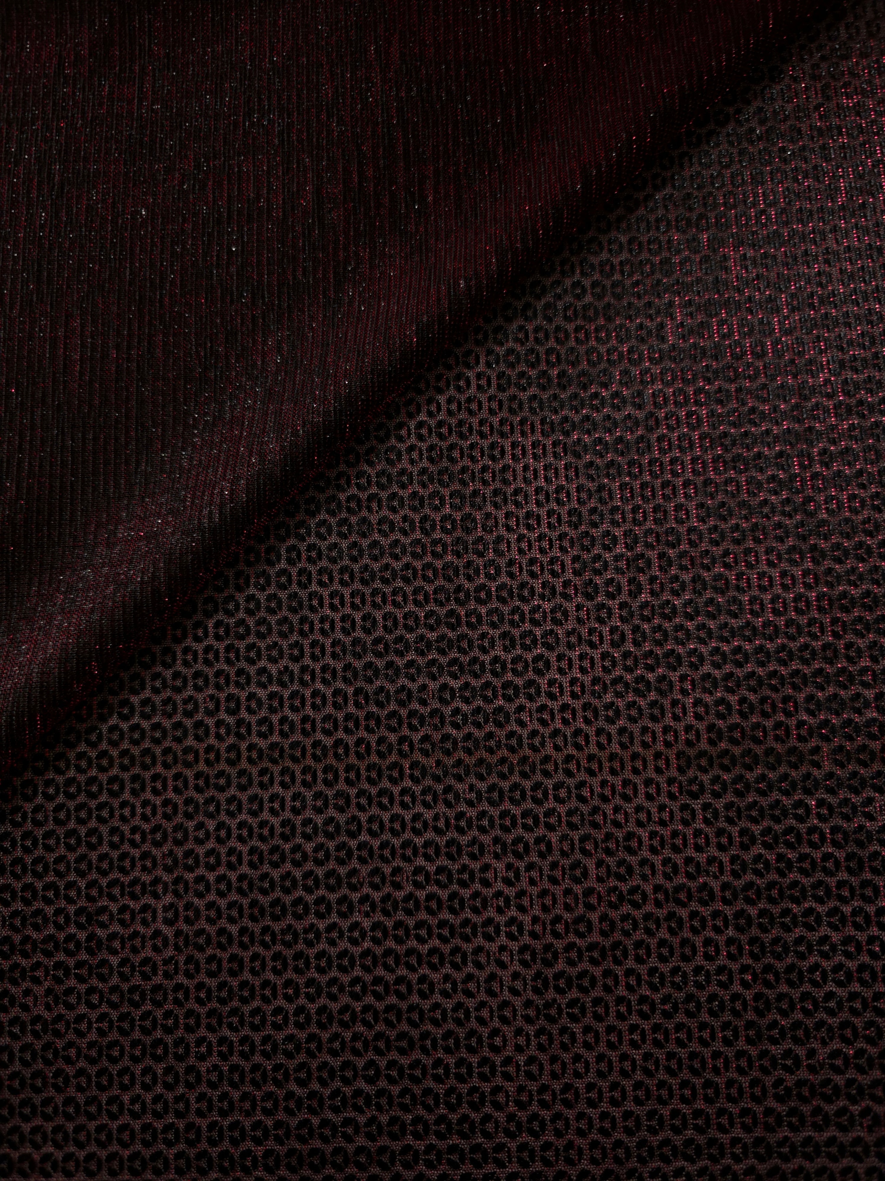 Front and back of Burgundy Red Sheer Circle Shimmer Stretch Tulle Fabric showing transparent knit structure, circle motif and stretch