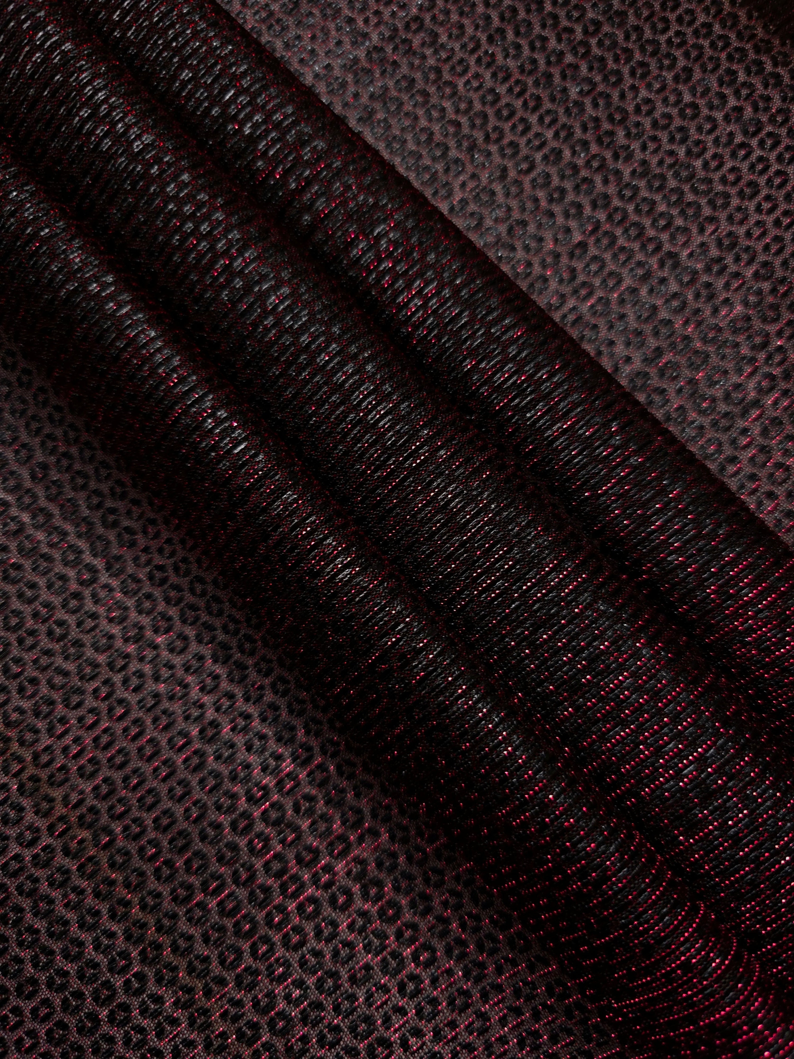 Layered Burgundy Red Sheer Circle Shimmer Stretch Tulle Fabric showing overlapping circles, luminous depth and airy transparency