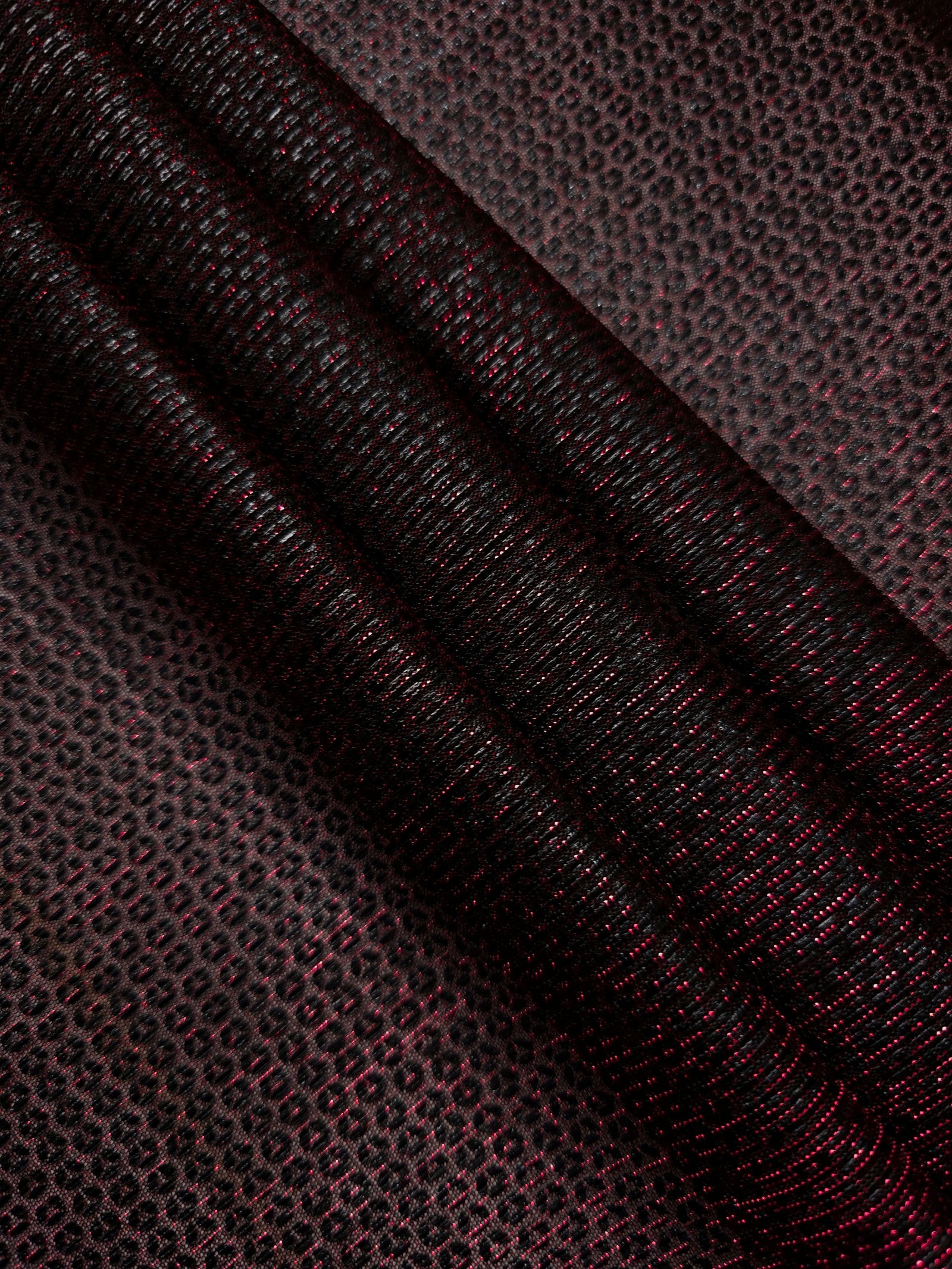 Layered Burgundy Red Sheer Circle Shimmer Stretch Tulle Fabric showing overlapping circles, luminous depth and airy transparency
