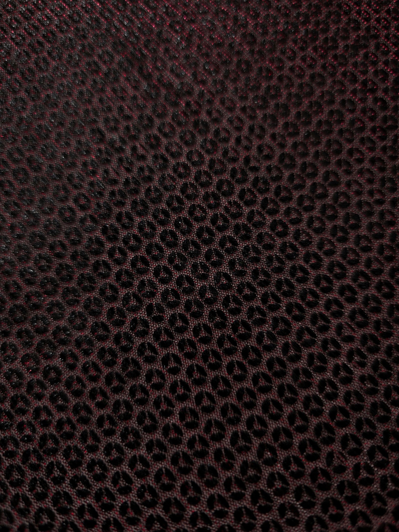 Surface detail of Burgundy Red Sheer Circle Shimmer Stretch Tulle Fabric highlighting reflective circle scale and lightweight tulle texture