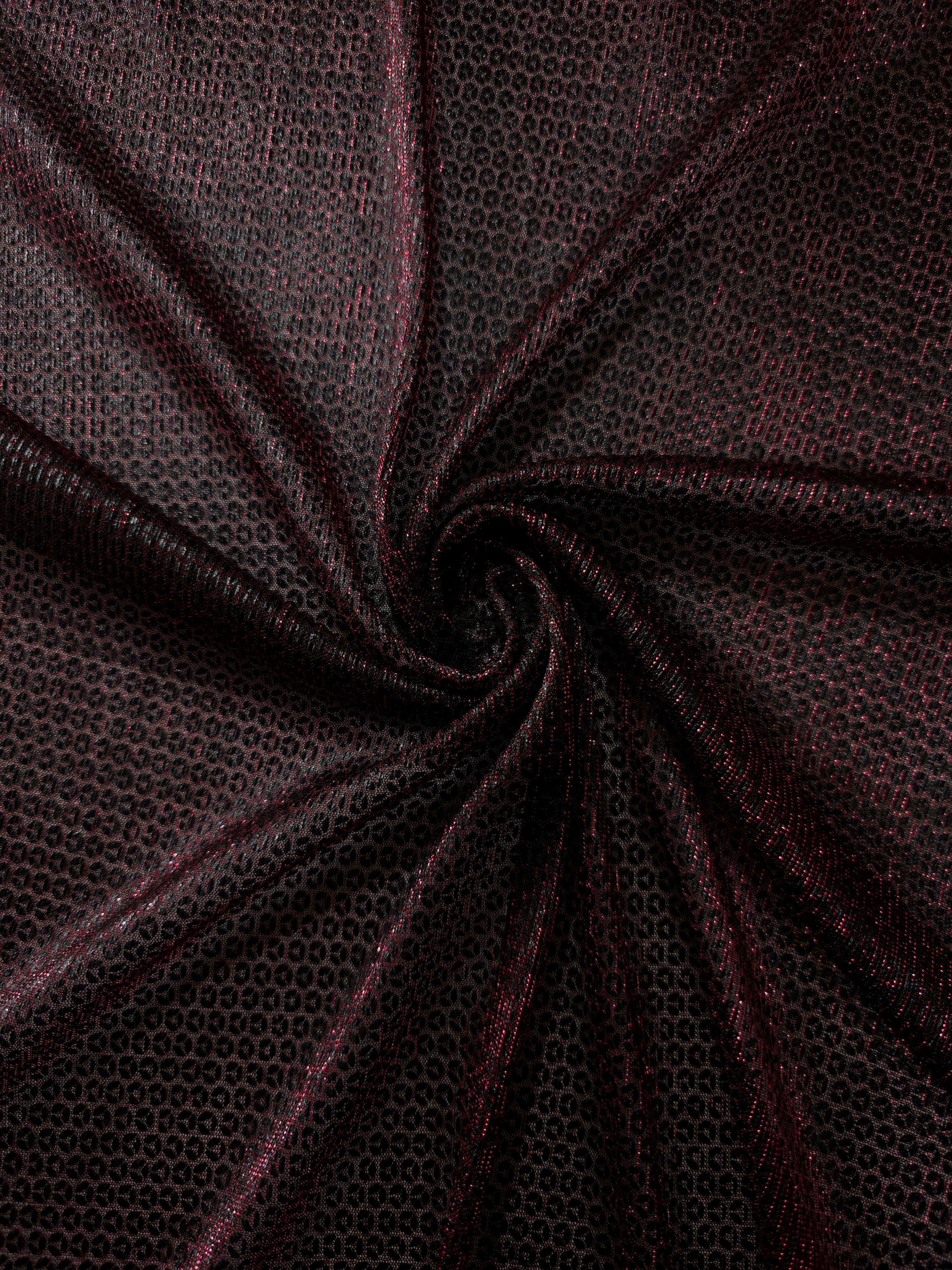 Swirl-draped Burgundy Red Sheer Circle Shimmer Stretch Tulle Fabric showing circular highlights shifting through flexible movement