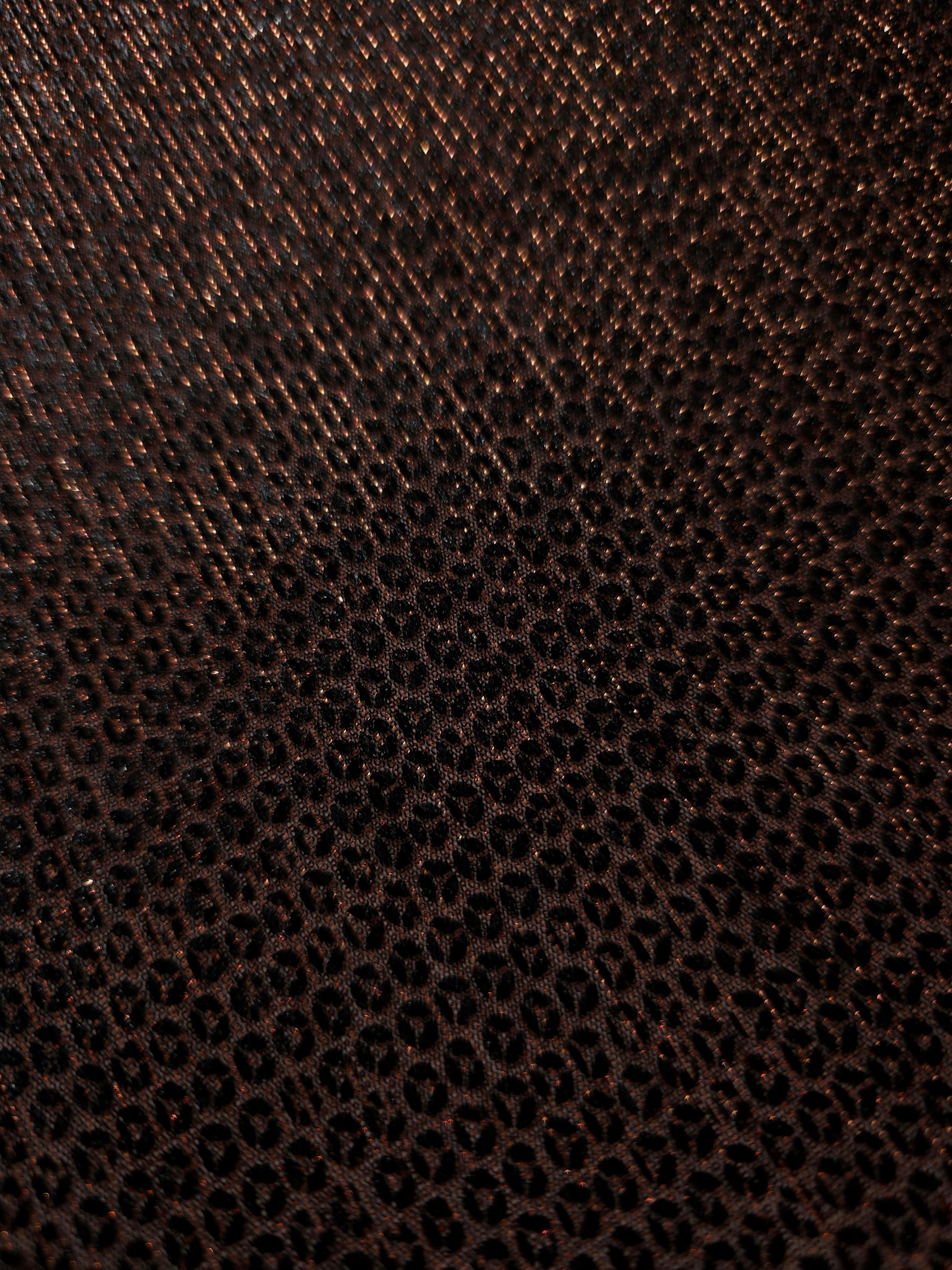 Close-up of Burnt Copper Sheer Circle Shimmer Stretch Tulle Fabric revealing the circular shimmer repeat and fine sheer mesh