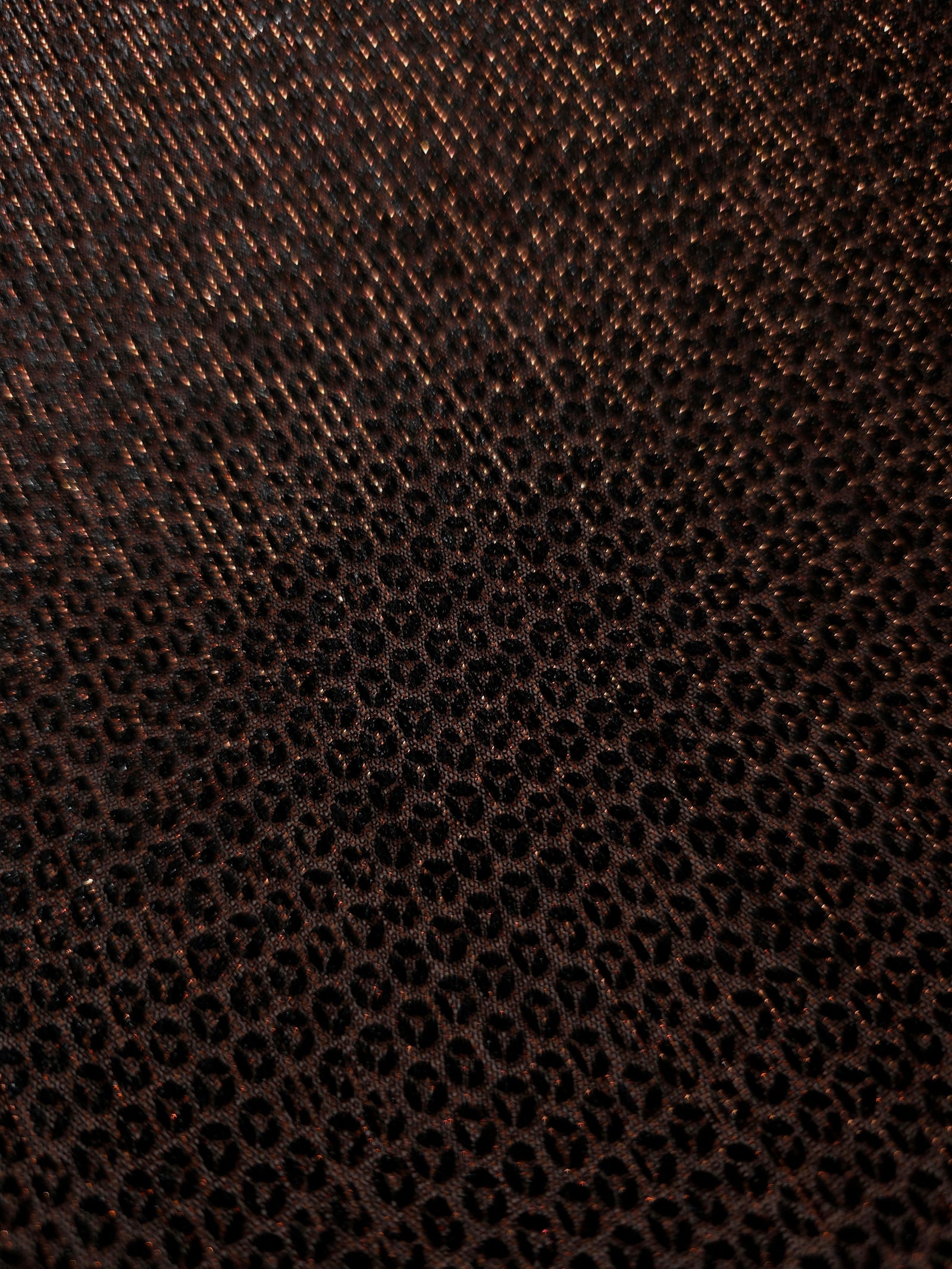 Close-up of Burnt Copper Sheer Circle Shimmer Stretch Tulle Fabric revealing the circular shimmer repeat and fine sheer mesh