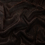 Draped Burnt Copper Sheer Circle Shimmer Stretch Tulle Fabric showing reflective round motifs across soft fluid folds