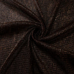 Swirl-draped Burnt Copper Sheer Circle Shimmer Stretch Tulle Fabric showing circular highlights shifting through flexible movement