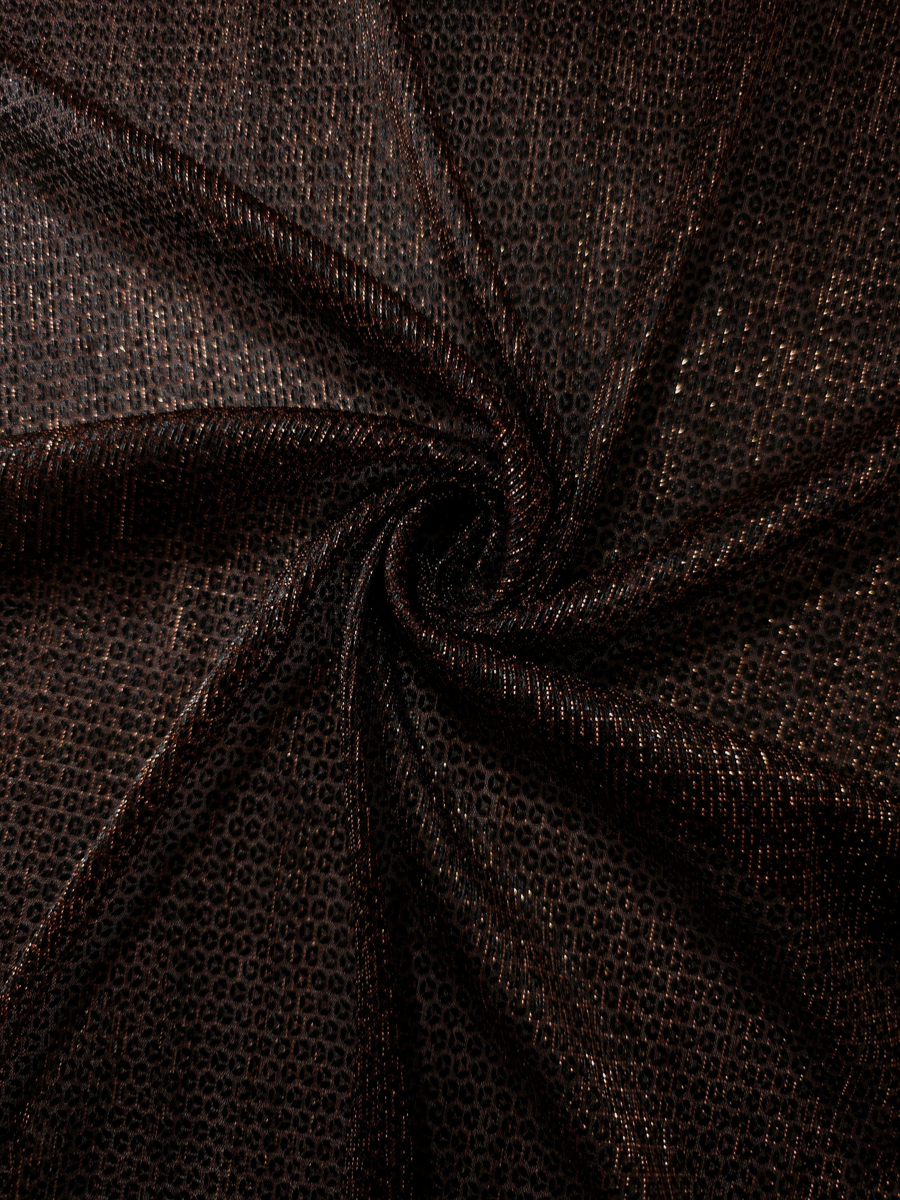 Swirl-draped Burnt Copper Sheer Circle Shimmer Stretch Tulle Fabric showing circular highlights shifting through flexible movement
