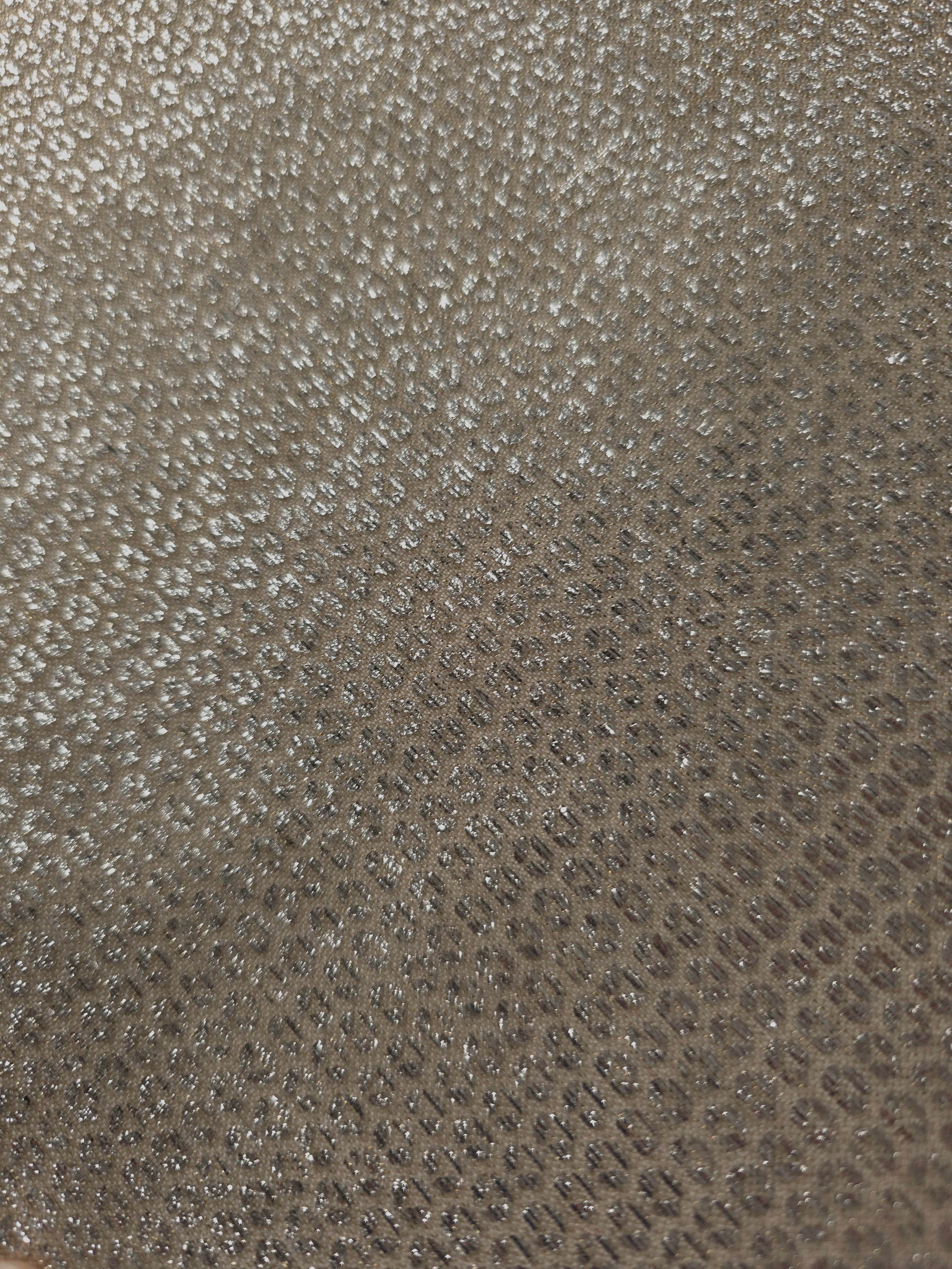 Close-up of Champagne Gold Sheer Circle Shimmer Stretch Tulle Fabric revealing the circular shimmer repeat and fine sheer mesh