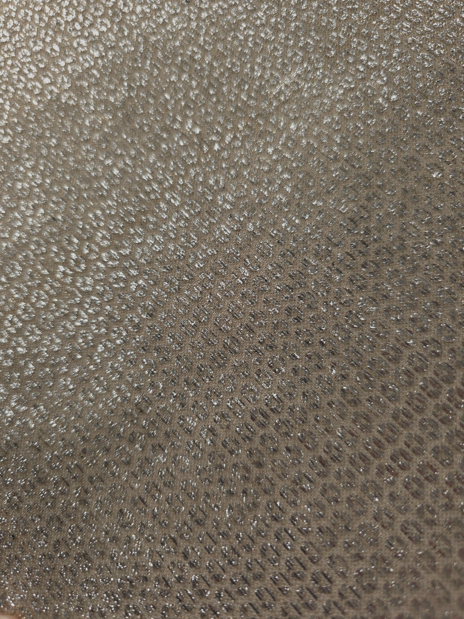 Close-up of Champagne Gold Sheer Circle Shimmer Stretch Tulle Fabric revealing the circular shimmer repeat and fine sheer mesh