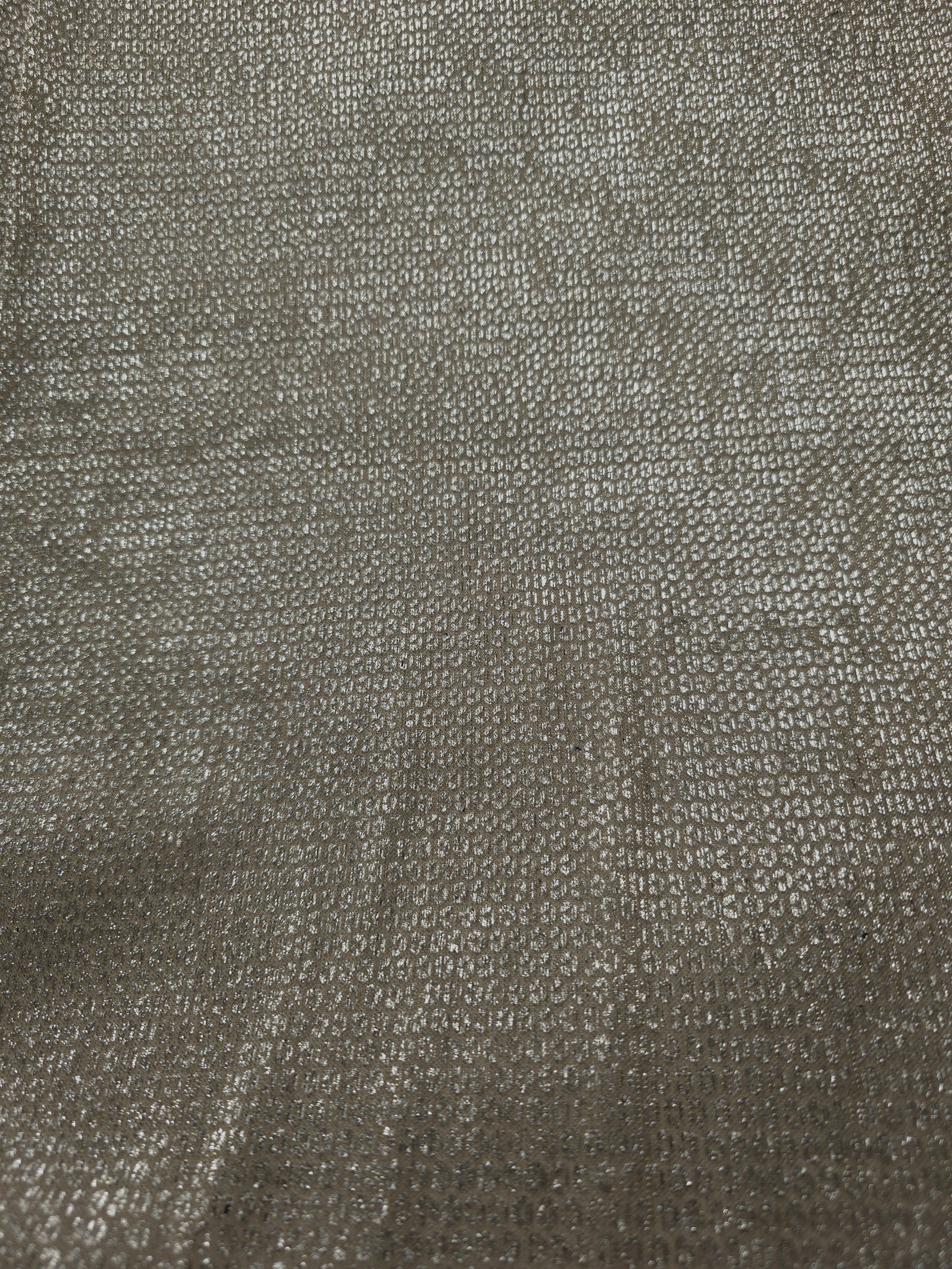 Surface detail of Champagne Gold Sheer Circle Shimmer Stretch Tulle Fabric highlighting reflective circle scale and lightweight tulle texture