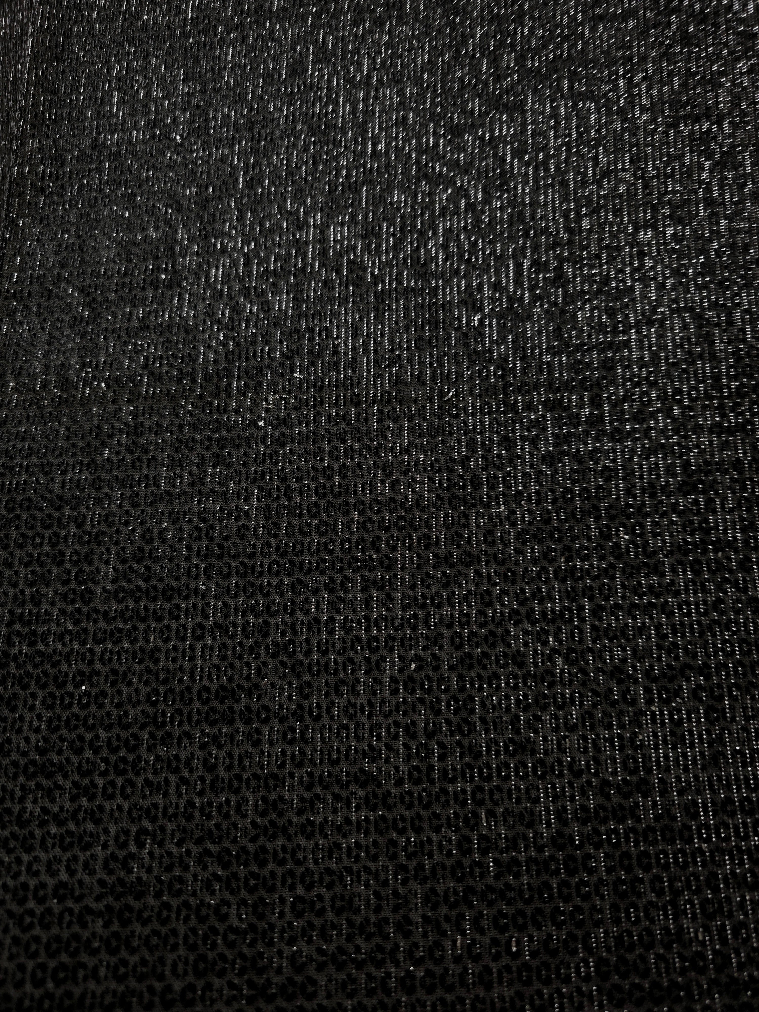 Close-up of Charcoal Silver Sheer Circle Shimmer Stretch Tulle Fabric revealing the circular shimmer repeat and fine sheer mesh